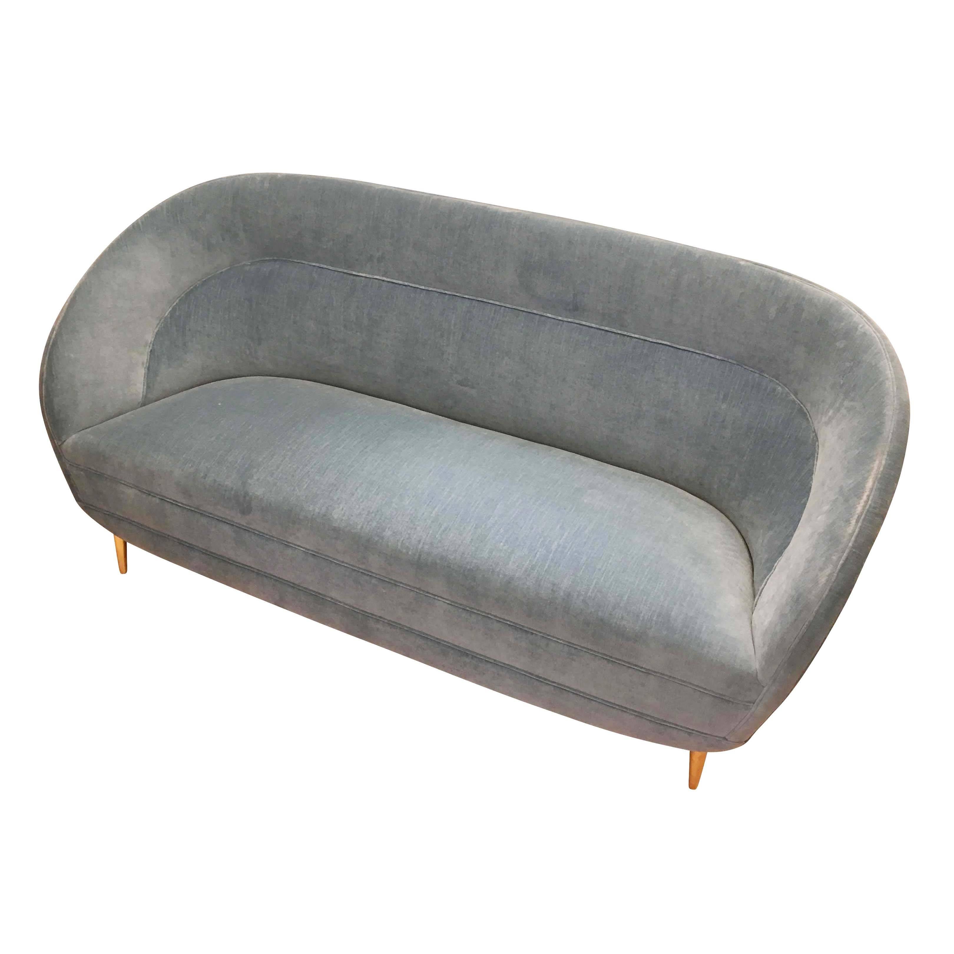 Curvaceous midcentury loveseat by Italian furniture manufacturer ISA. Has been re-upholstered in a blue velvet. The four tapered feet are brass.

Condition: Excellent vintage condition, minor wear consistent with age and use

Measure: Width