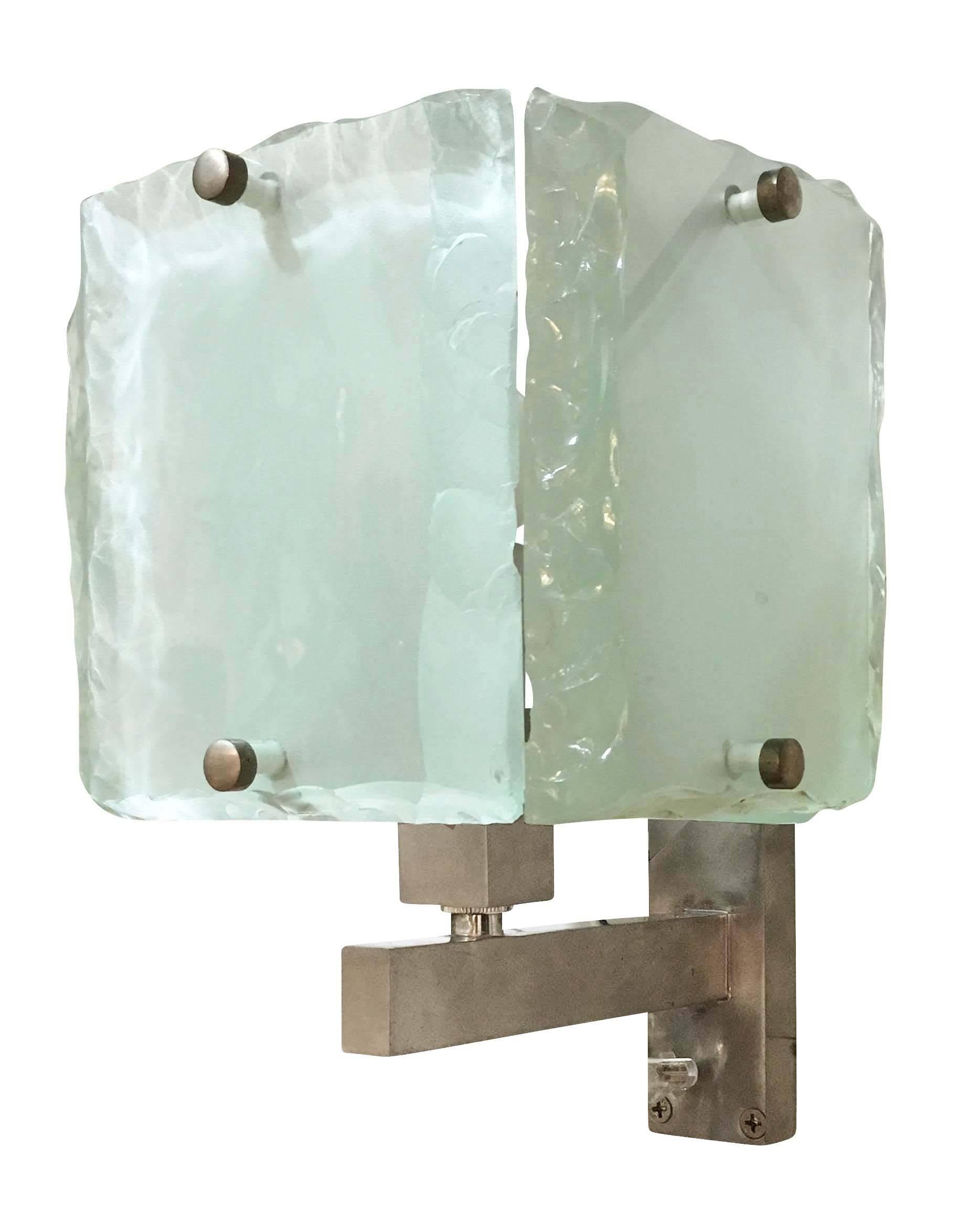 Italian midcentury sconces by ZeroQuattro each composed of four hand chiselled glass slabs which are polished on the exterior and frosted on the interior. The glasses are mounted on brushed nickel frame holding on candelabra socket. Can be mounted