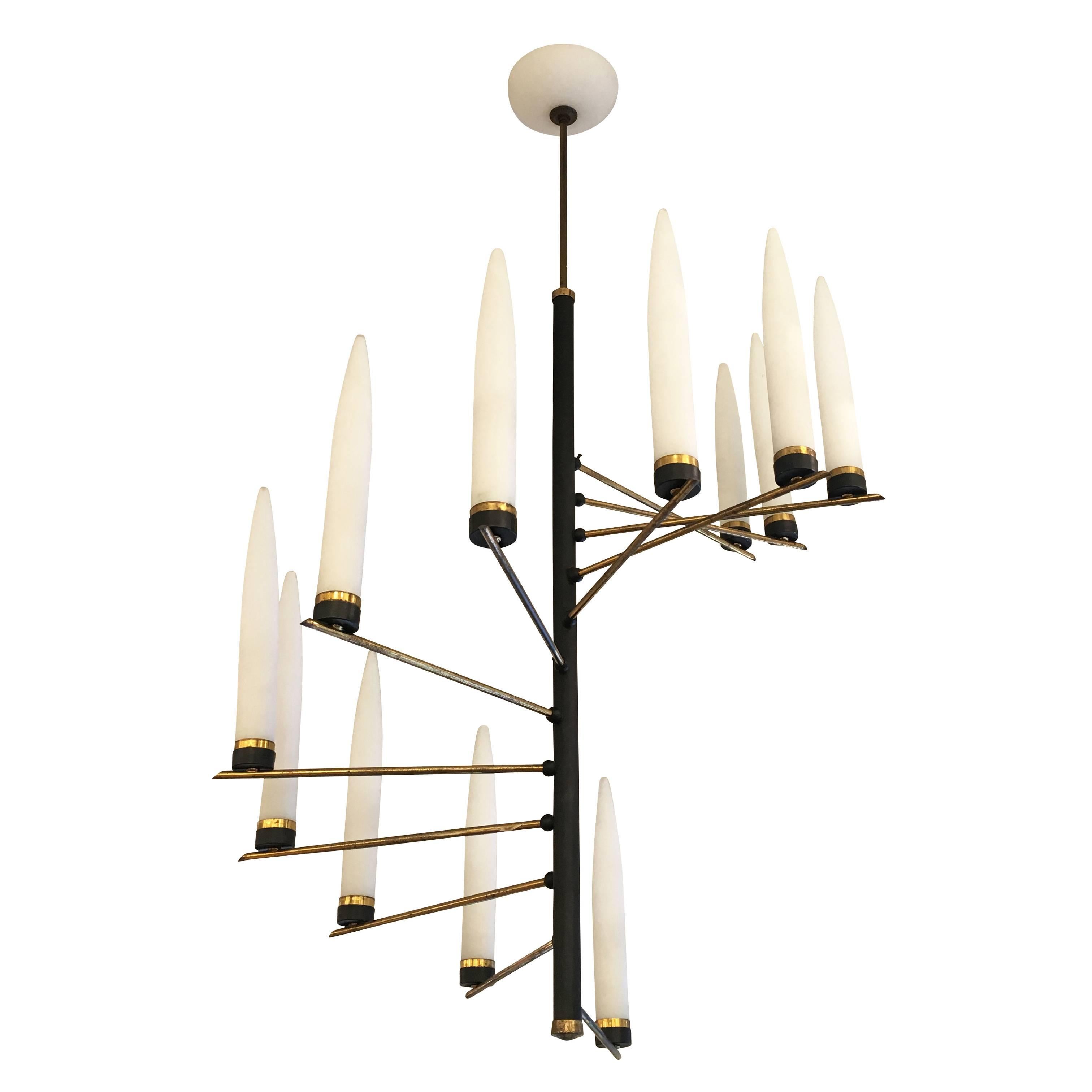 Charming Italian midcentury spiral chandelier. The narrow frosted glasses were typical of this manufacturer. The frame is lacquered black with brass details and the canopy is made of frosted glass. Since these pieces were hand made some of the arms