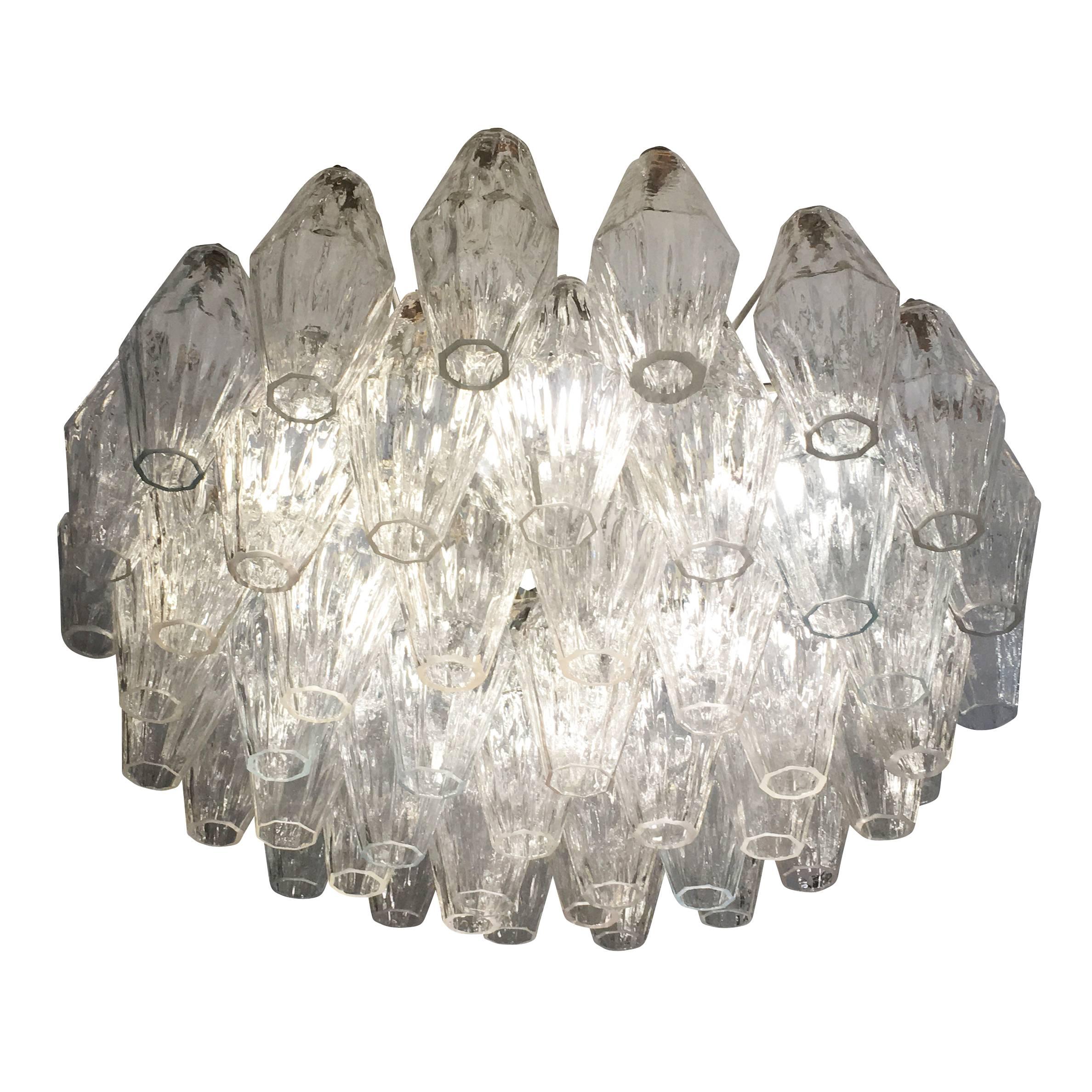 Murano glass poliedri chandelier attributed to Venini. Each glass, handblown in a mold, is clear with a textured surface. The glasses are larger in size than those seen on most of these chandeliers. The frame is white and holds six regular sockets.