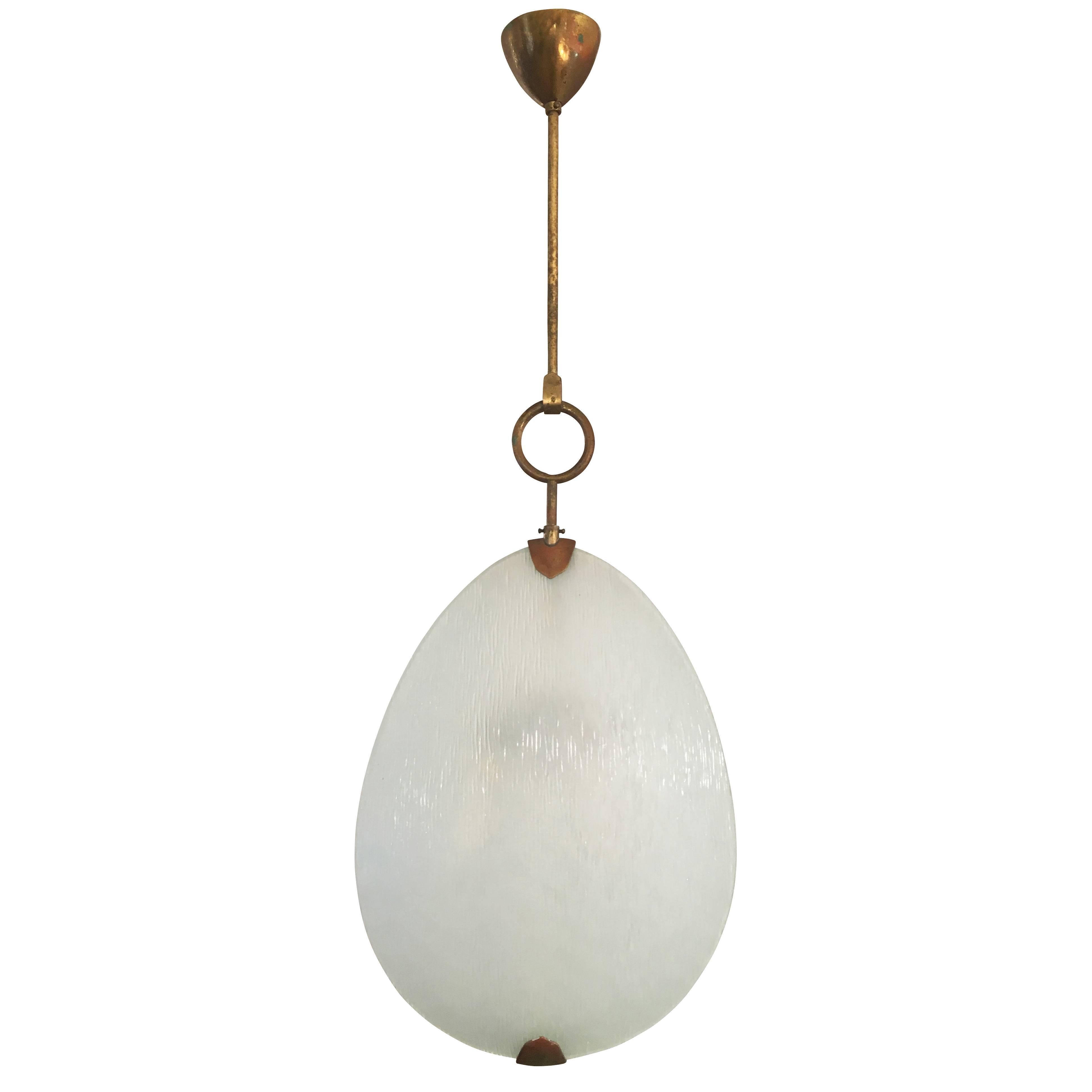 Exquisite Fontana Arte pendant designed by Max Ingrand in the 1960s featuring two textured glass shades. Holds two candelabra sockets. Hardware is brass.

Condition: The glass is in excellent condition. The brass frame is tarnished but can be