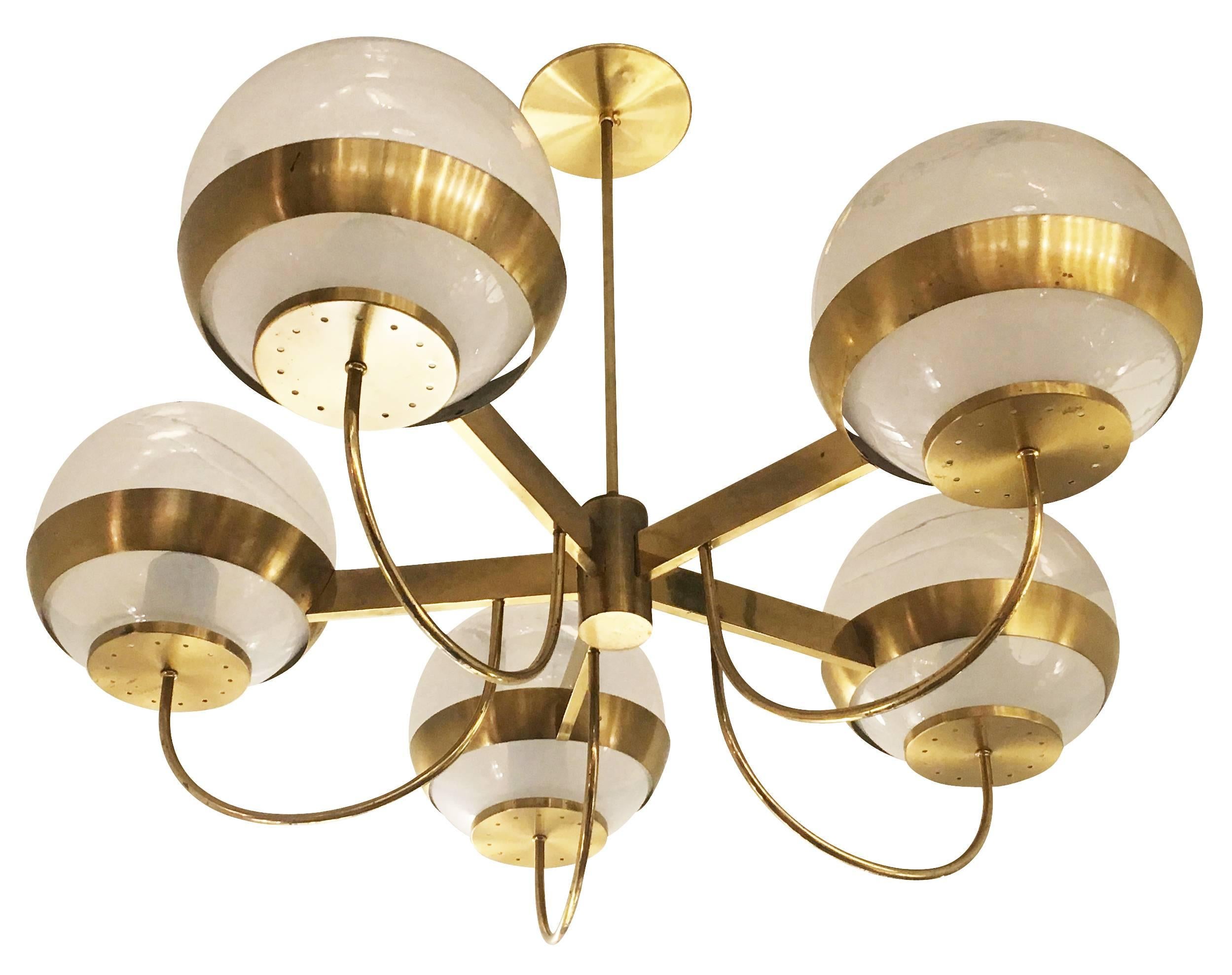 Brass chandelier made by Lamperti in the 1970s. The five glass shades gradually fade from white at the bottom to clear at the top. Holds five regular sockets. Stem can be adjusted as needed.

Condition: Excellent vintage condition, minor wear