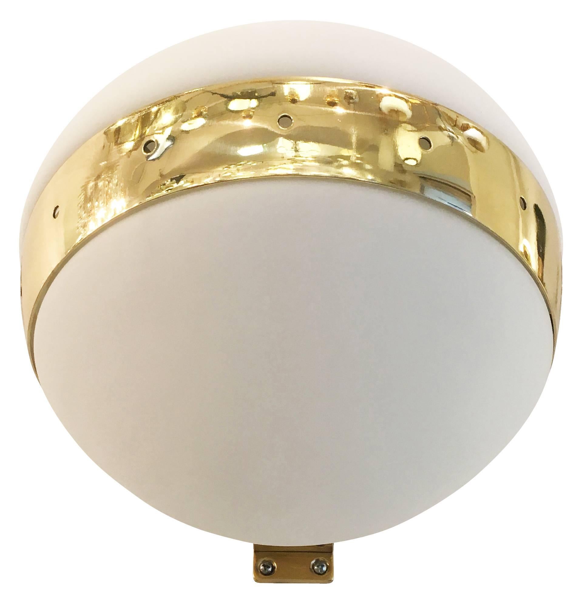 Round Italian midcentury wall lights, each featuring a polished brass frame with two frosted glass shades. Three available. Sold Individually. Price per light.

Condition: Excellent vintage condition, minor wear consistent with age and