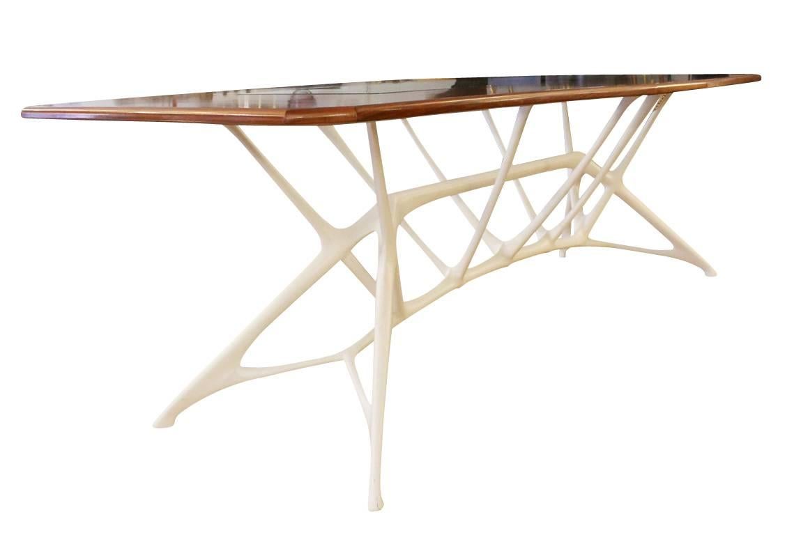 Large table made by contemporary studio Le Opere e i Giorni. Edition seven of ten. The wood top has a glass cutout which allows the sculptural legs to be seen. The organic legs are white painted metal and fiberglass.
