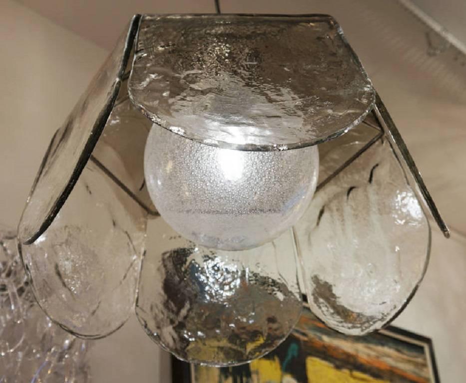 Large Carlo Nason for Mazzega pendant or chandelier. A light metal structure holds six large glass petals darker on top and clear but texture rich in the lower part. The light socket that is inside is covered by a bubble infused glass globe that