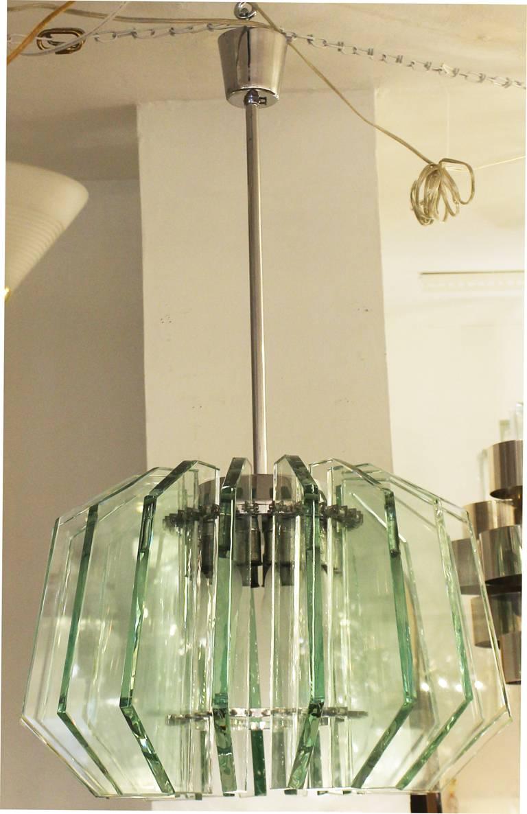 Stunning Fontana Arte pendant composed of 18 hand chiseled glass slabs mounted to a central chrome frame. This is a variant of model 2294A. Holds 18 candelabra sockets. Height of stem can be adjusted upon request.