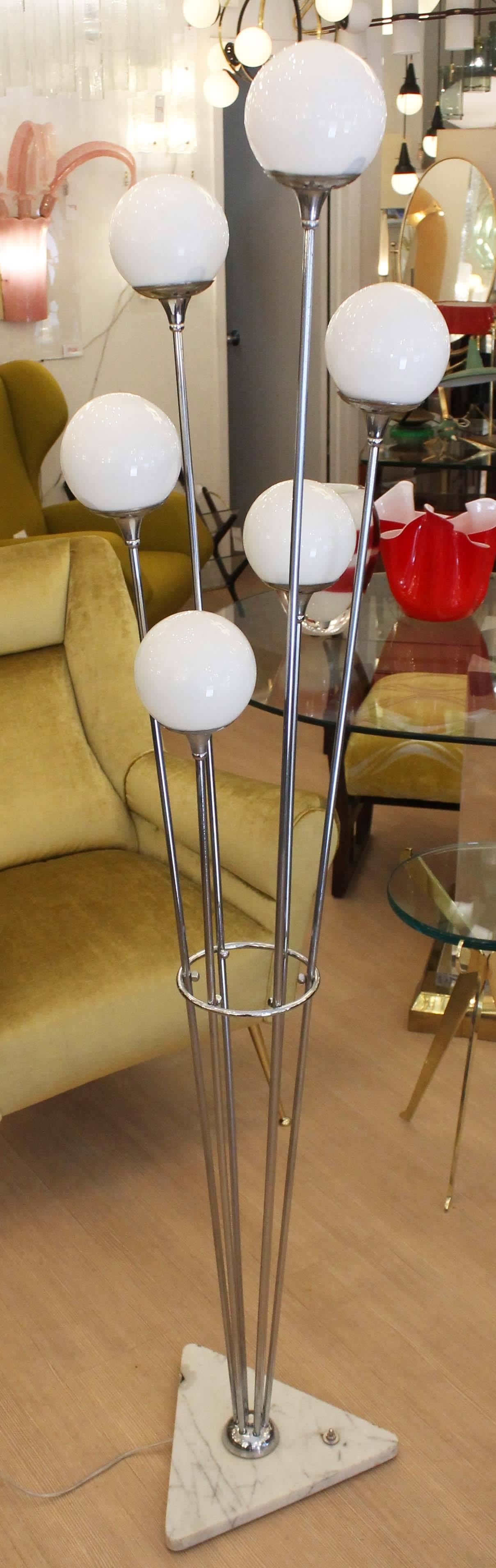 Beautiful floor lamp with six staggered chrome stems ending in round glass shades. The triangular base with foot switch is marble. The shades are glossy but can be substituted for frosted ones upon request. Also available in black.
