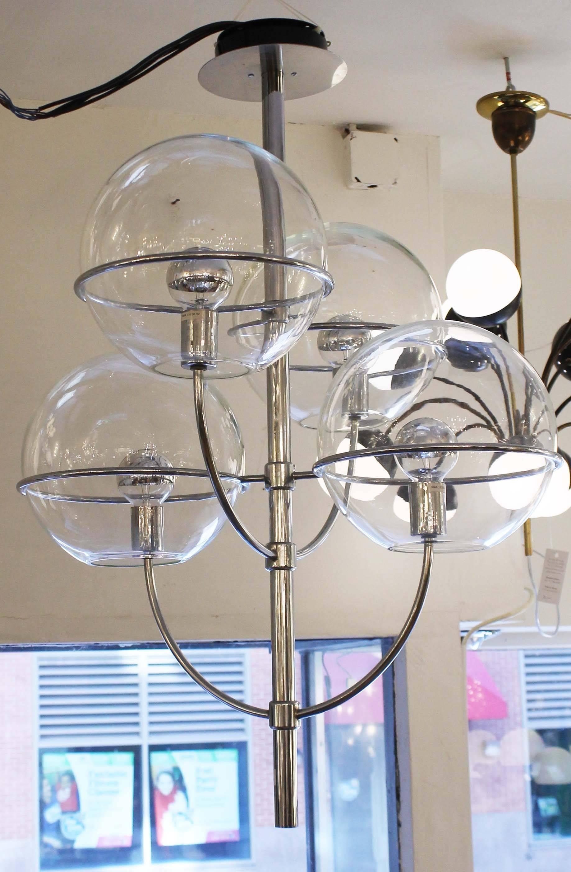 Lindon model chandelier designed by Vico Magistretti for O-Luce featuring four large glass shades on a chrome frame. Holds four regular edison sockets with the capacity of providing a lot of light. Shades can be frosted on request. Comes with a 20”