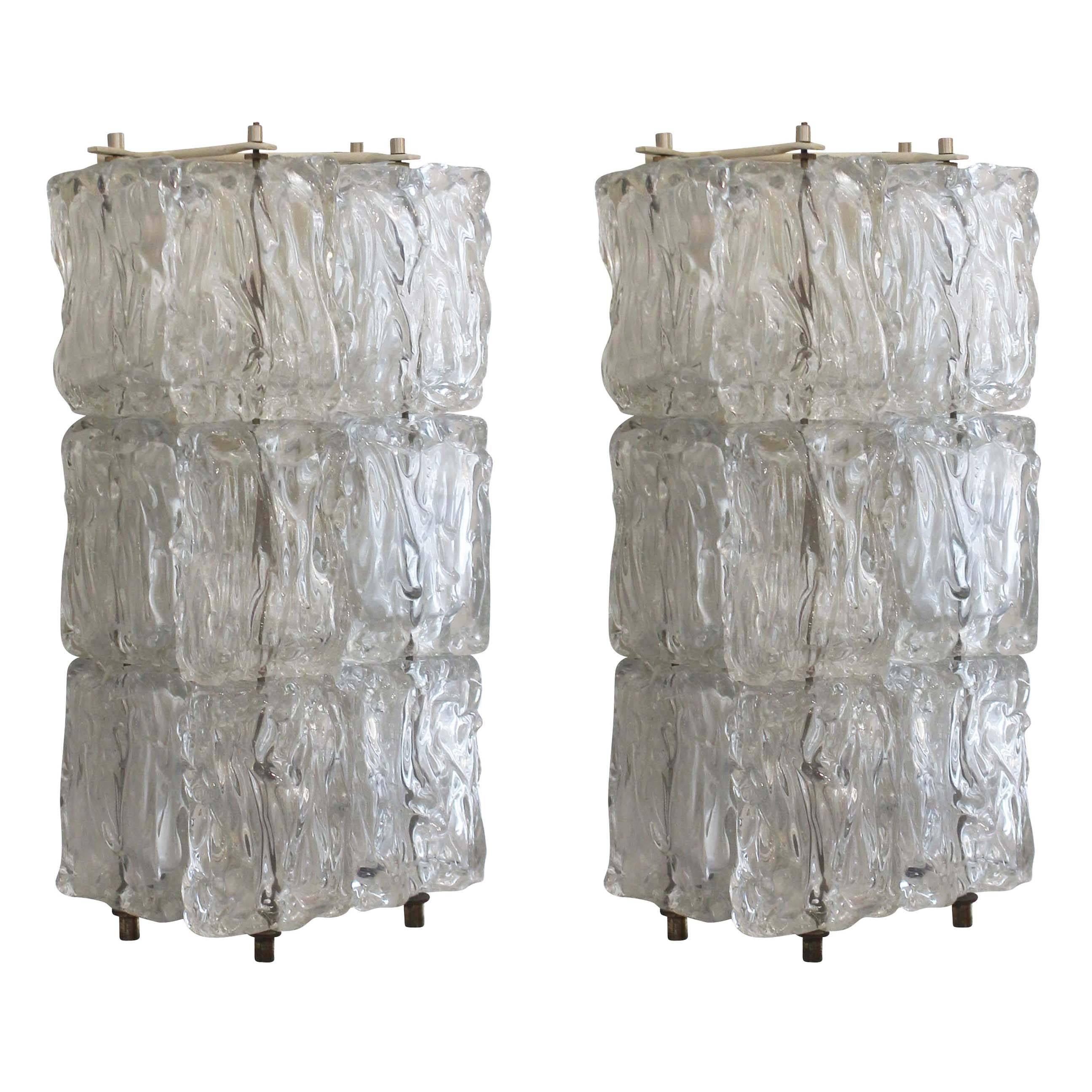 Pair of Murano glass sconces each composed of the four columns of textured glasses. Each column has three glasses. The frame is off-white metal and holds two candelabra sockets.

Available for viewing at Gaspare Asaro-Italian Modern in NYC