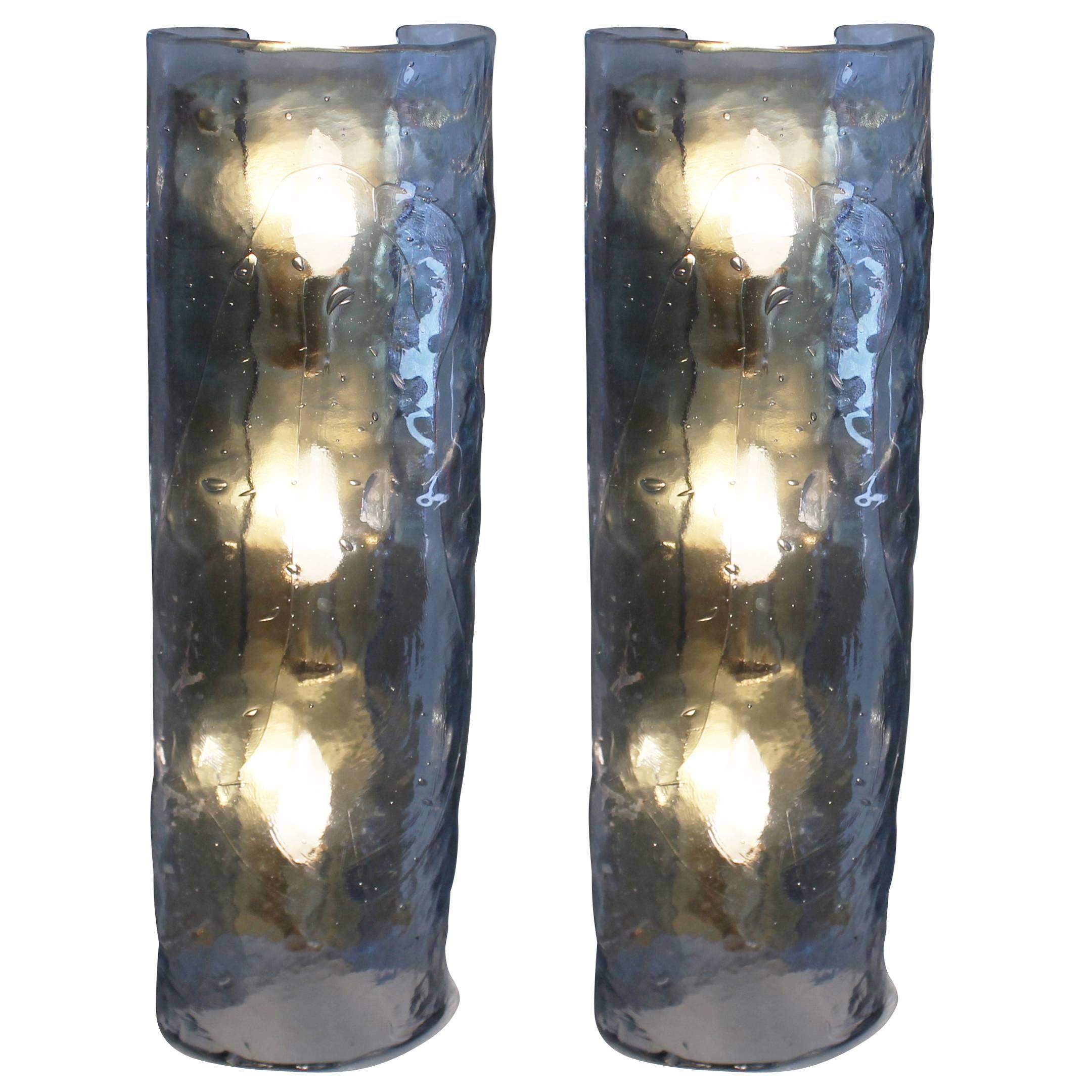 Large Murano glass sconces taken from the University of Catania in Sicily. The glass is textured and has some intentional imperfections and bubbles. The hardware is brass and holds three candelabra sockets. Can also be used as ceiling lights.