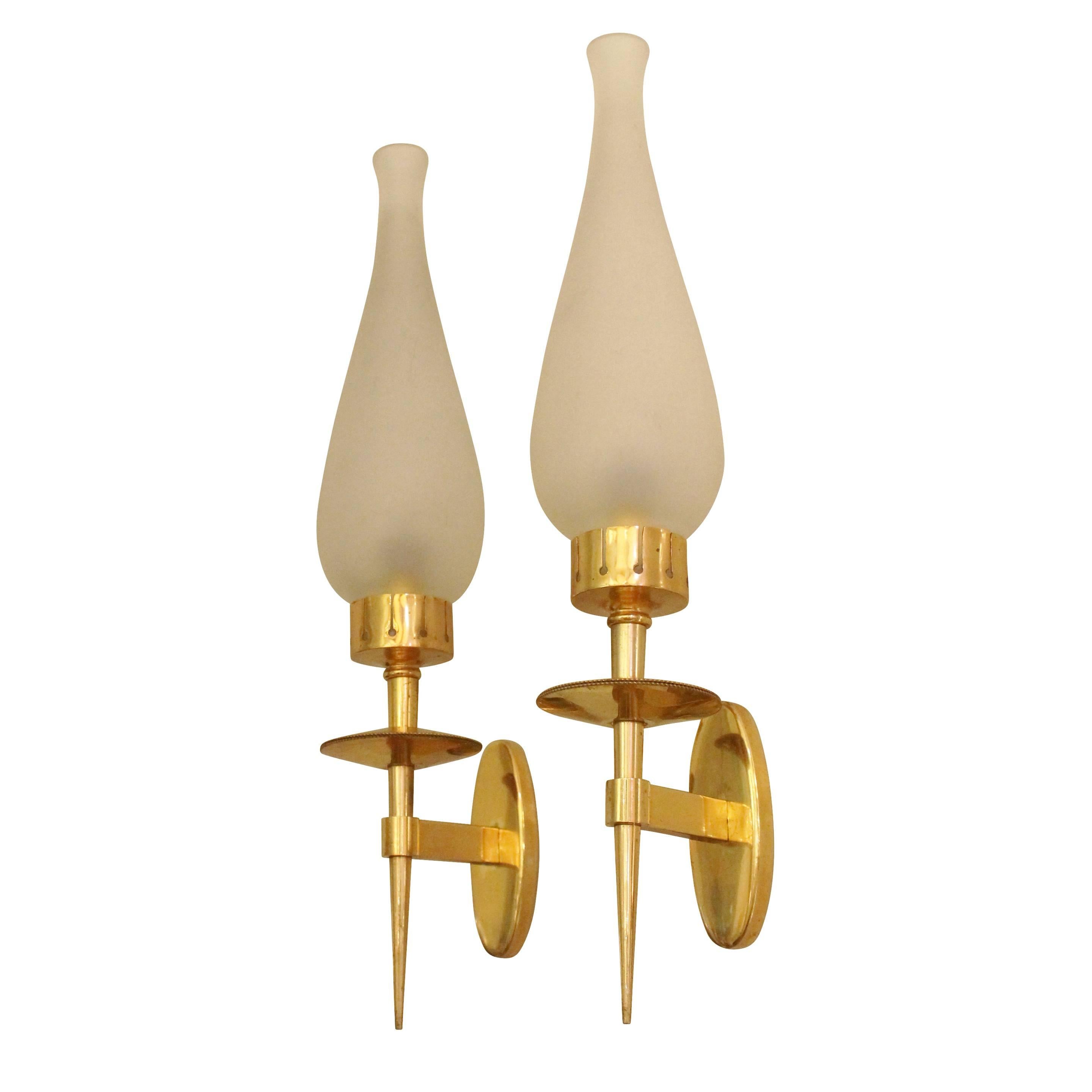 Elegant elongated wall lights in the manner of Angelo Lelli for Arredoluce. Each features a brass frame holding a beautifully shaped frosted glass shade.