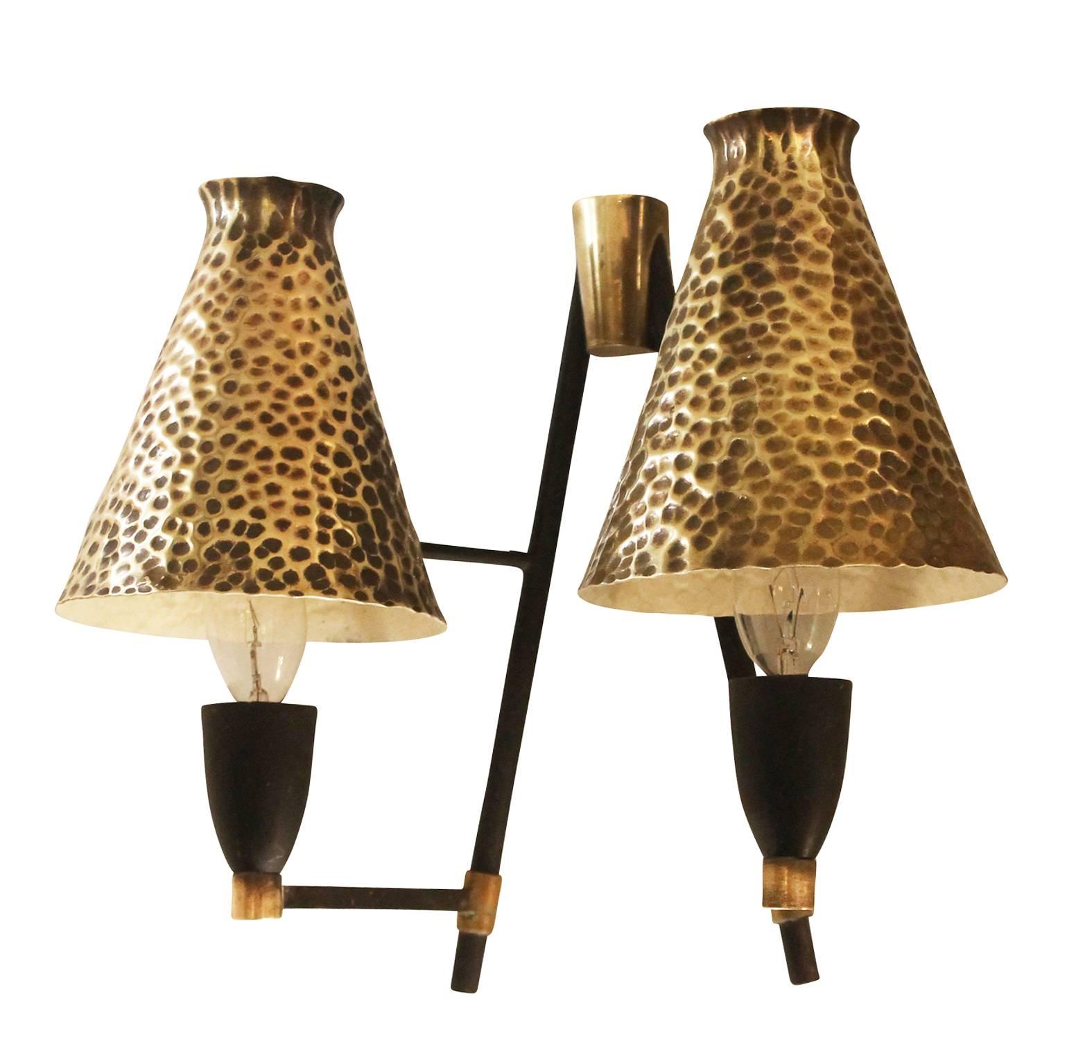 Pair of unusual Mid-Century wall lights with hammered brass shades. Frame is black and brass. Each holds two candelabra sockets.
