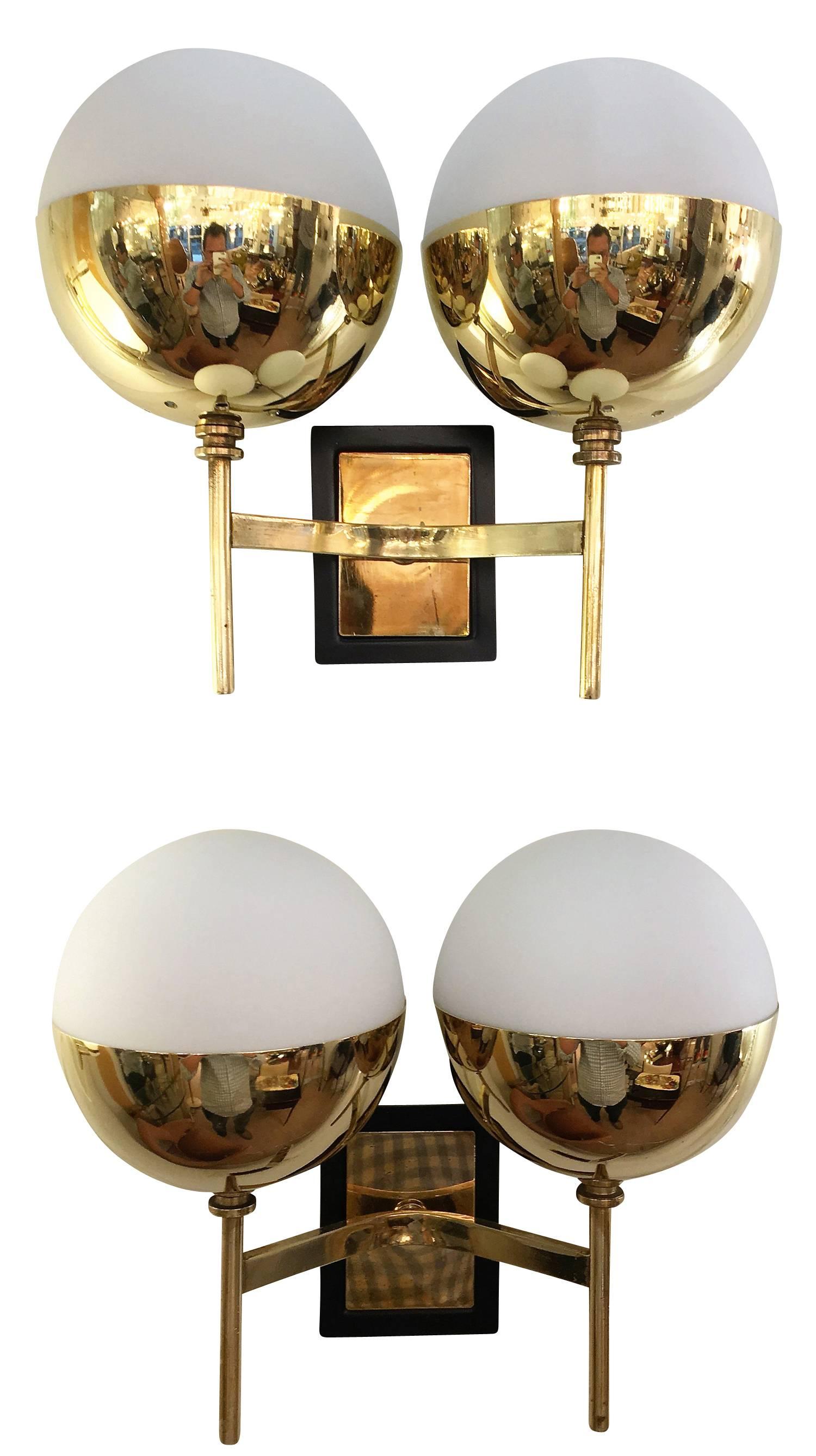 Set of four diminutive wall lights in the manner of Stilnovo each featuring two frosted glass shades on a brass frame. The backplates have a black lacquered edge. Price is per pair.

Available for viewing at Gaspare Asaro-Italian Modern in NYC