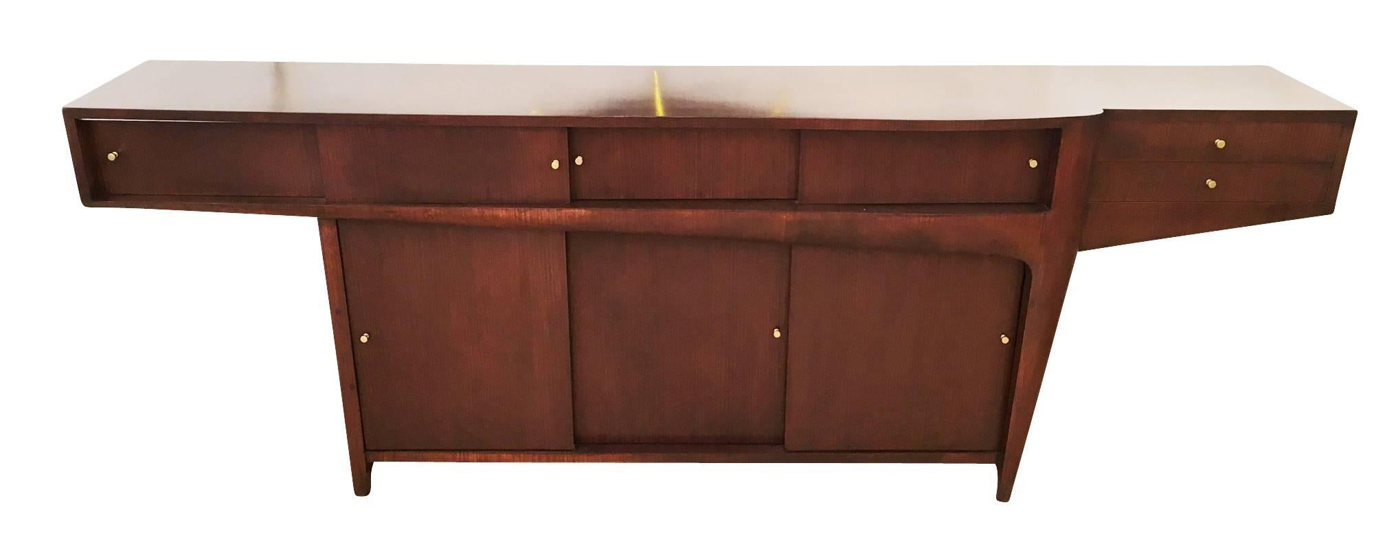 Large 1960s rosewood credenza with an exceptional sleek design. On the upper level it has two compartments with four sliding doors and two drawers on one end. On the lower level it has two large compartments with three sliding doors.
