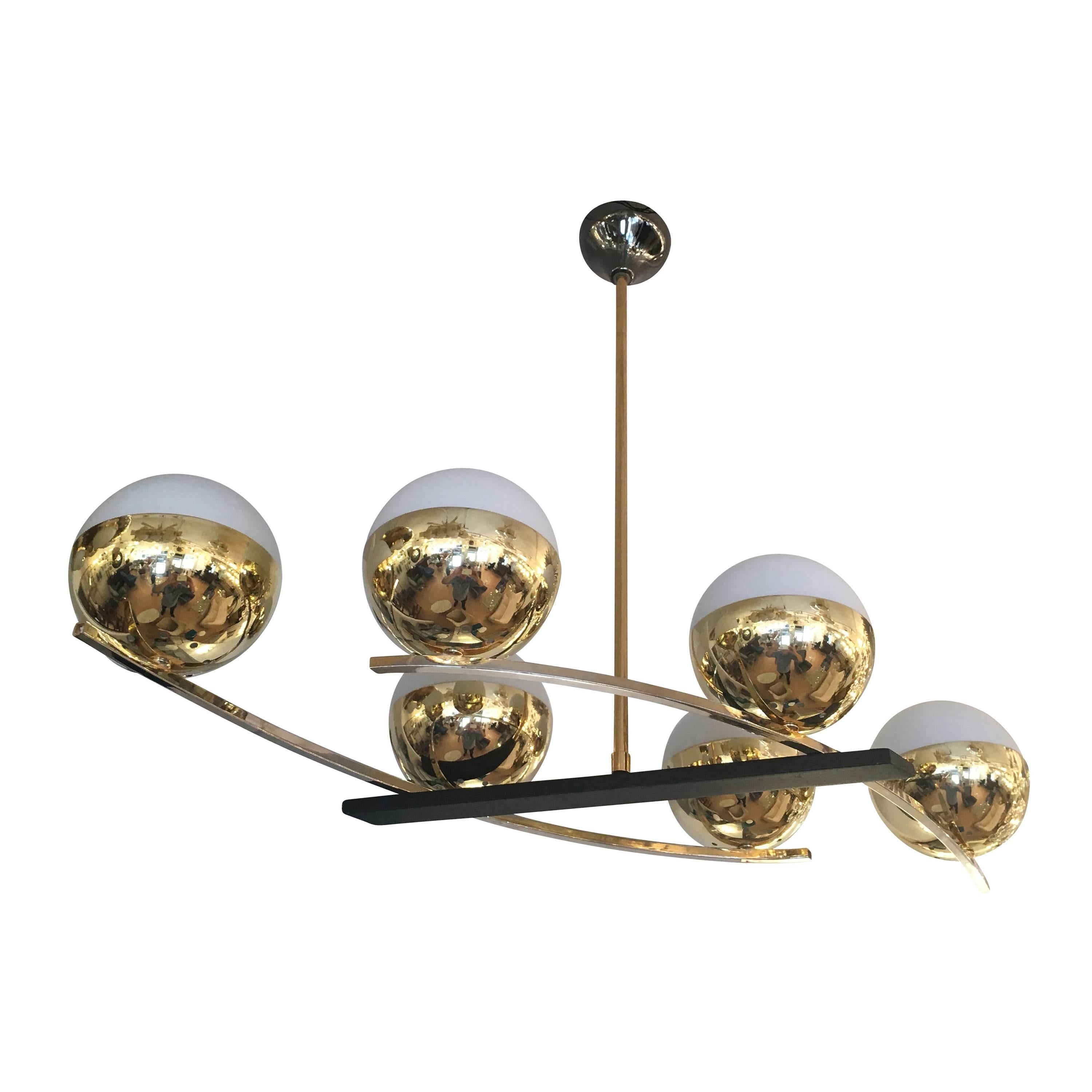 Beautifully designed French chandelier form the 1960s. The shade holders and stem are brass while the frames that hold the shades are polished steel. The plate connecting the two sides of the chandelier is lacquered black. The mixed metals are well