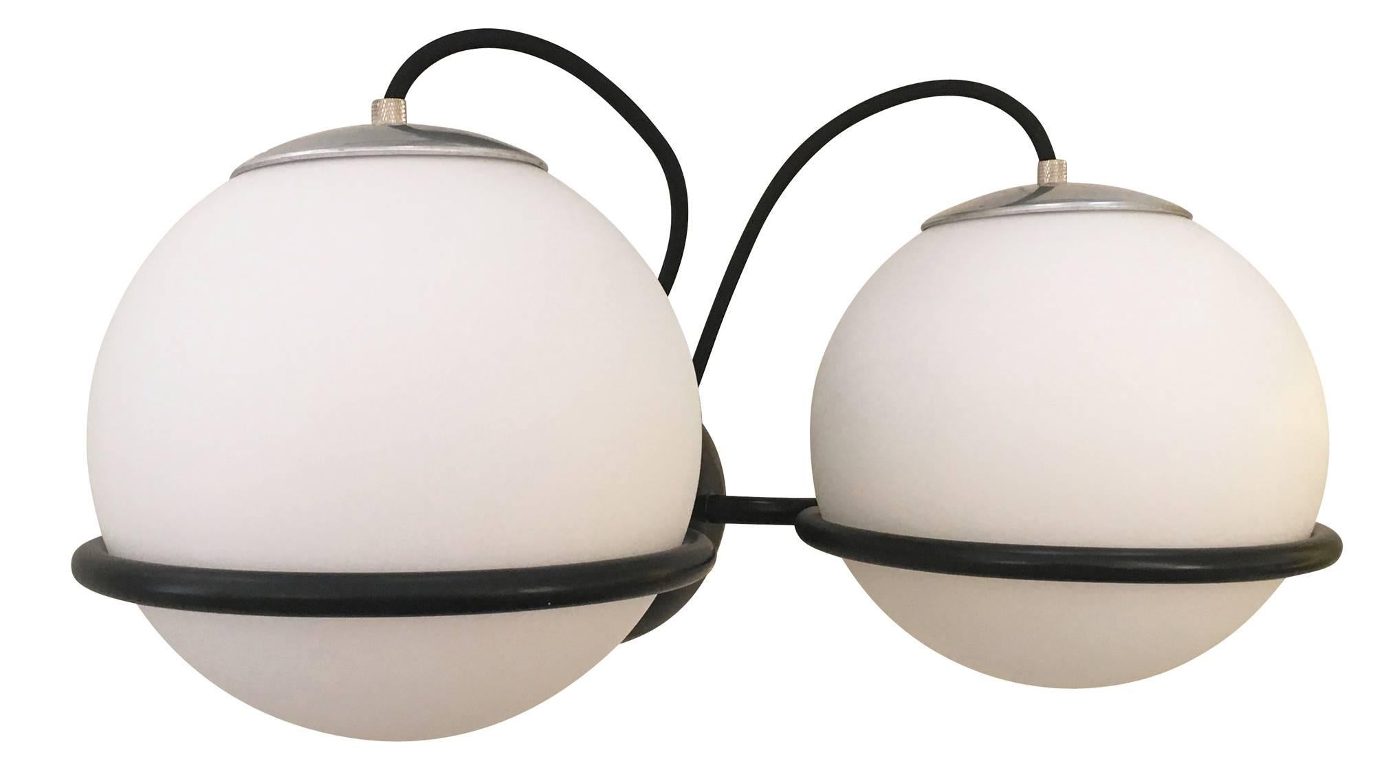 Unusually large sconces by Gino Sarfatti for Arteluce each featuring two large frosted glass globes on a black lacquered frame. The globes can be positioned with the wire upwards or downwards. Original label present on all of them. Also available
