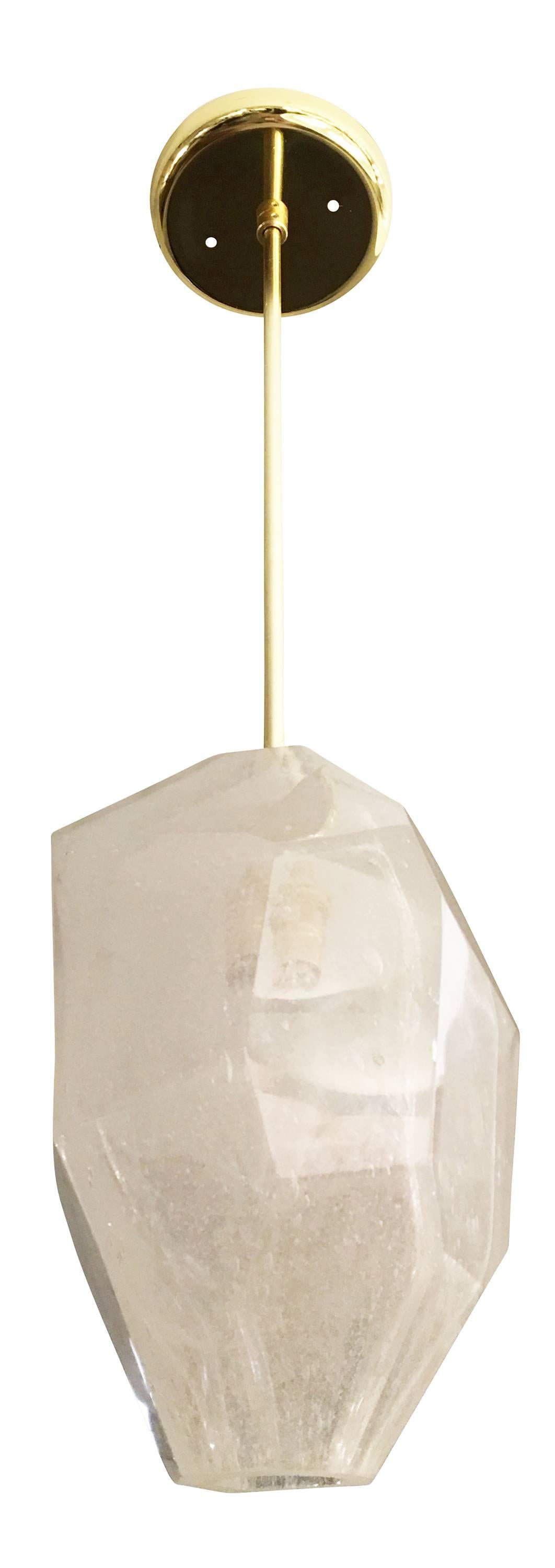 Sculptural pendants designed by Gaspare Asaro Studio consisting of a large faceted glass crystal. The glass, handmade in Murano, has a smooth surface and infused bubbles. The stem can be made in any finish and length. Holds one candelabra bulb.