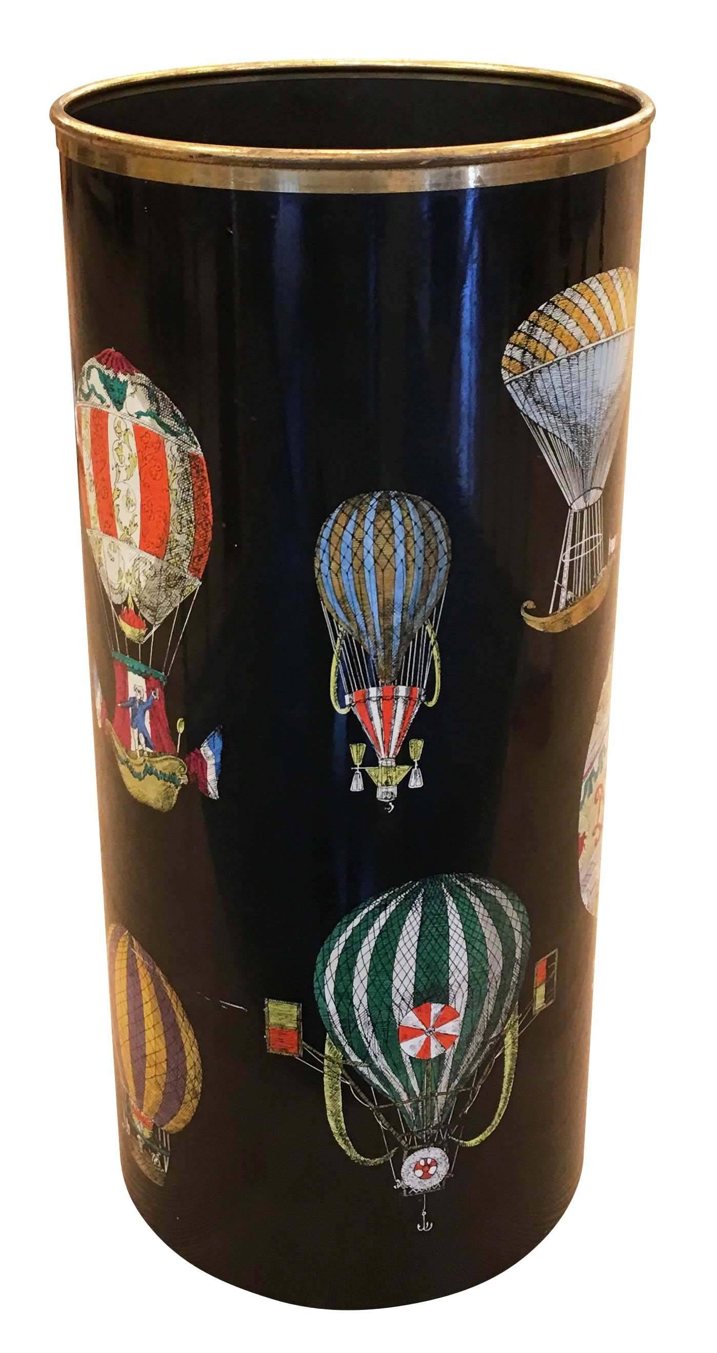 Piero Fornasetti “Mongolfiere” umbrella stand portraying a hot air balloon motif on black background. The rim is brass.