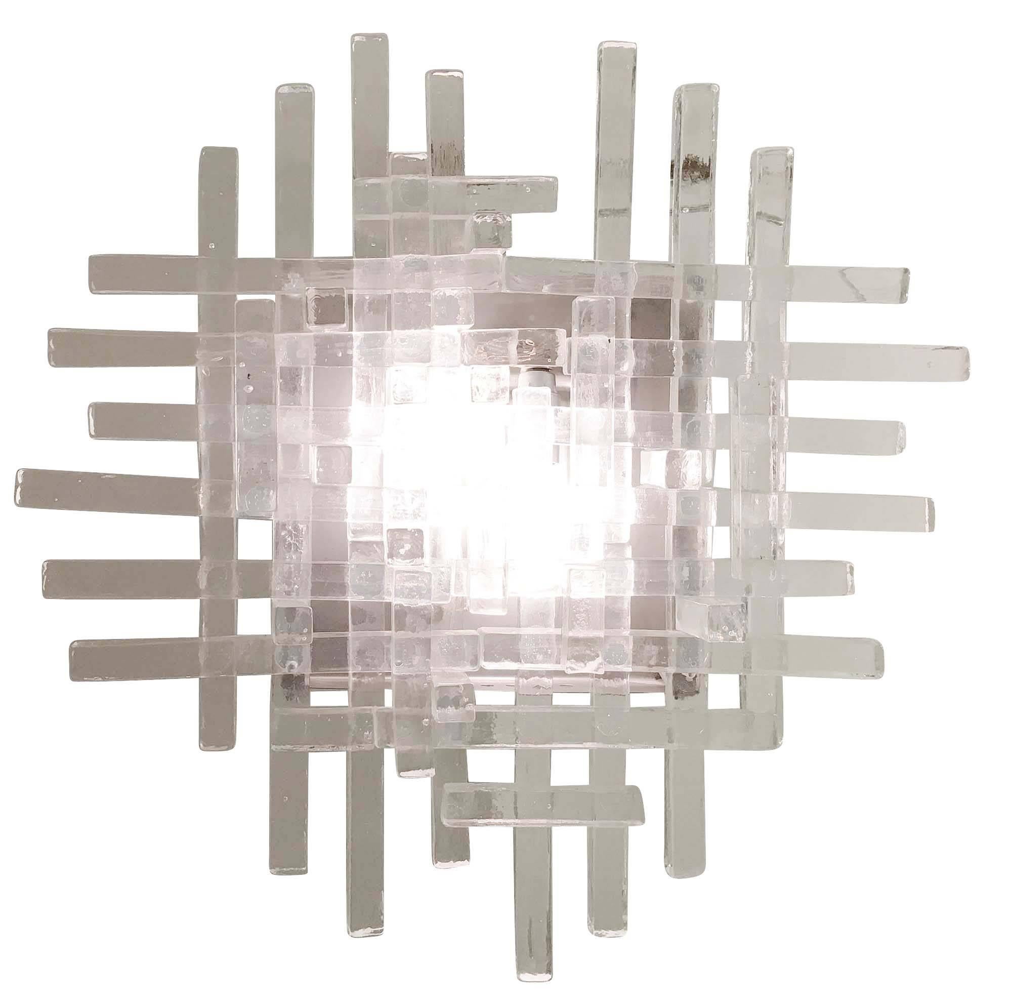 Stunning Poliarte wall light composed of dozens of glass rectangles of different sizes stacked together. The glass is clear but textured. Holds two candelabra sockets on a brushed metal frame. Six available.
