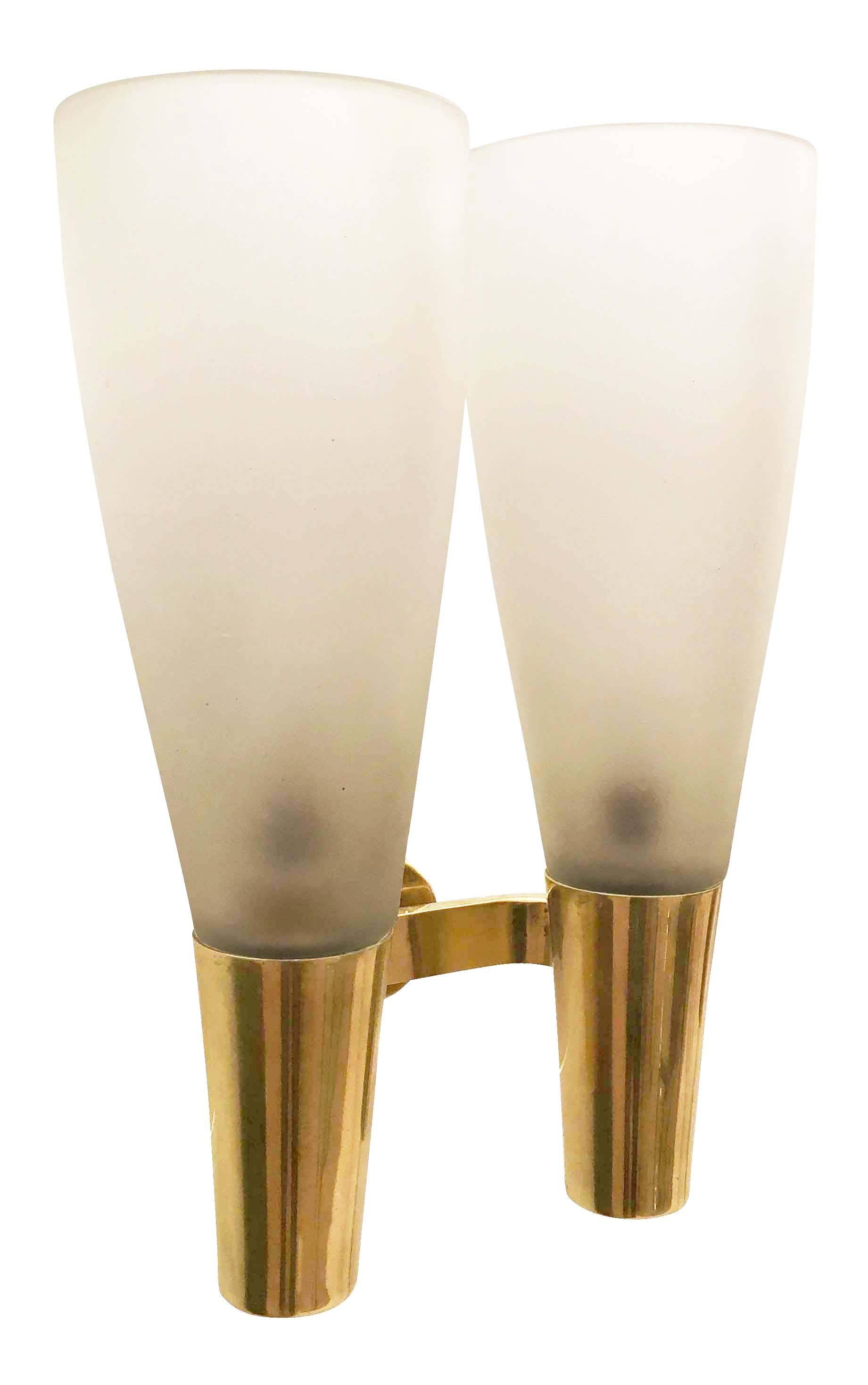 Pair of elegant sconces designed by Pietro Chiesa for Fontana Arte in 1936. Each sconce has two satin glass shades on a polished brass frame.
 