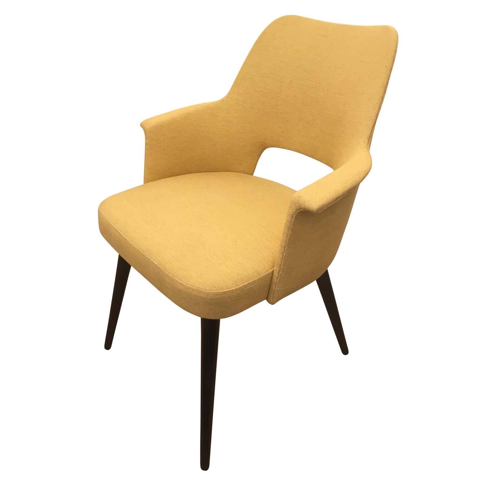 Elegant pair of chairs form the 1960s with wood legs. Can be purchased individually as accent armchairs or desk chairs. Only one has been upholstered in a yellow fabric for display purposes. Price per chair. Please contact us for upholstery options.