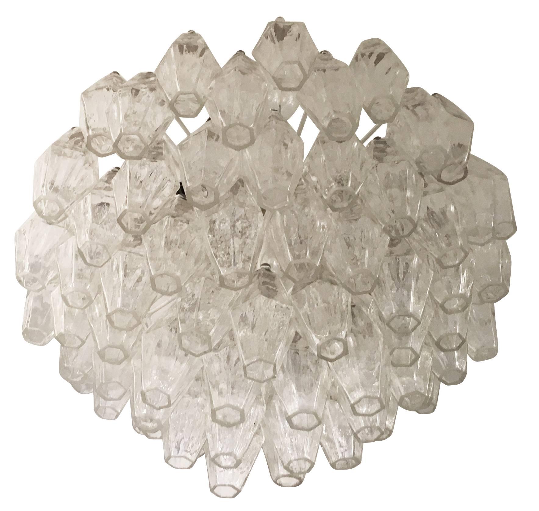Beautiful polyhedral chandelier by Carlo Scarpa for Venini from the 1960s. It features dozens of clear handblown Murano glasses on four tiers. Adding to the value of this piece are Venini markings on all the arms of the frame. Holds eleven