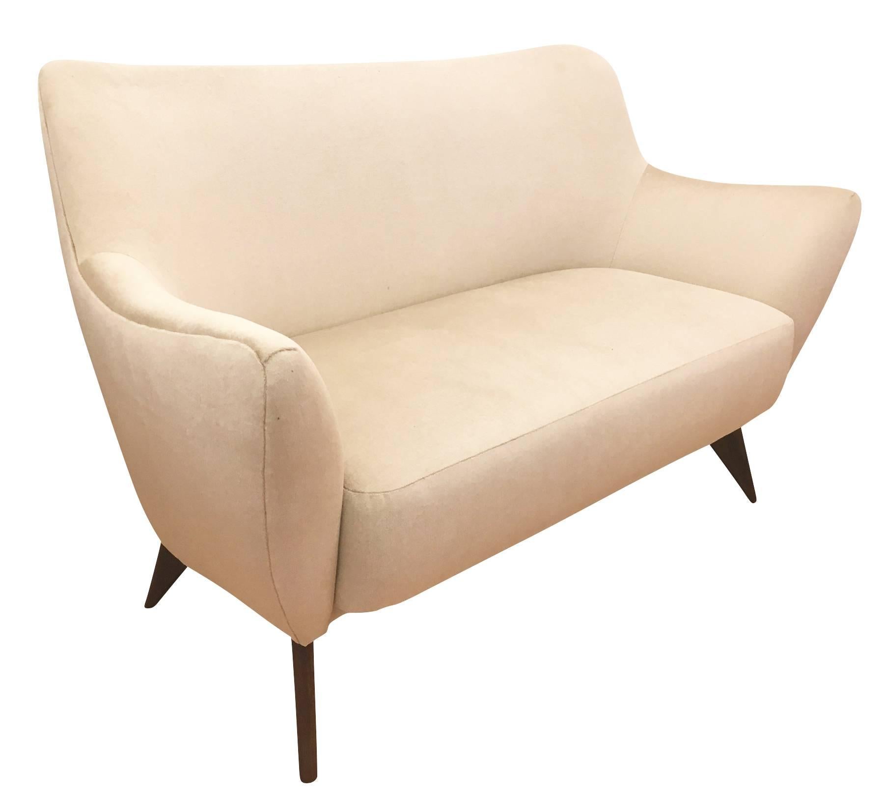 Beautifully designed and balanced “Perla” sofa by Guglielmo Veronesi for ISA from the 1950s. Its curved lines and tapered wooden legs give it a sensual and modern feel. Has been re-upholstered in a pearl velvet.

Available for viewing at Gaspare