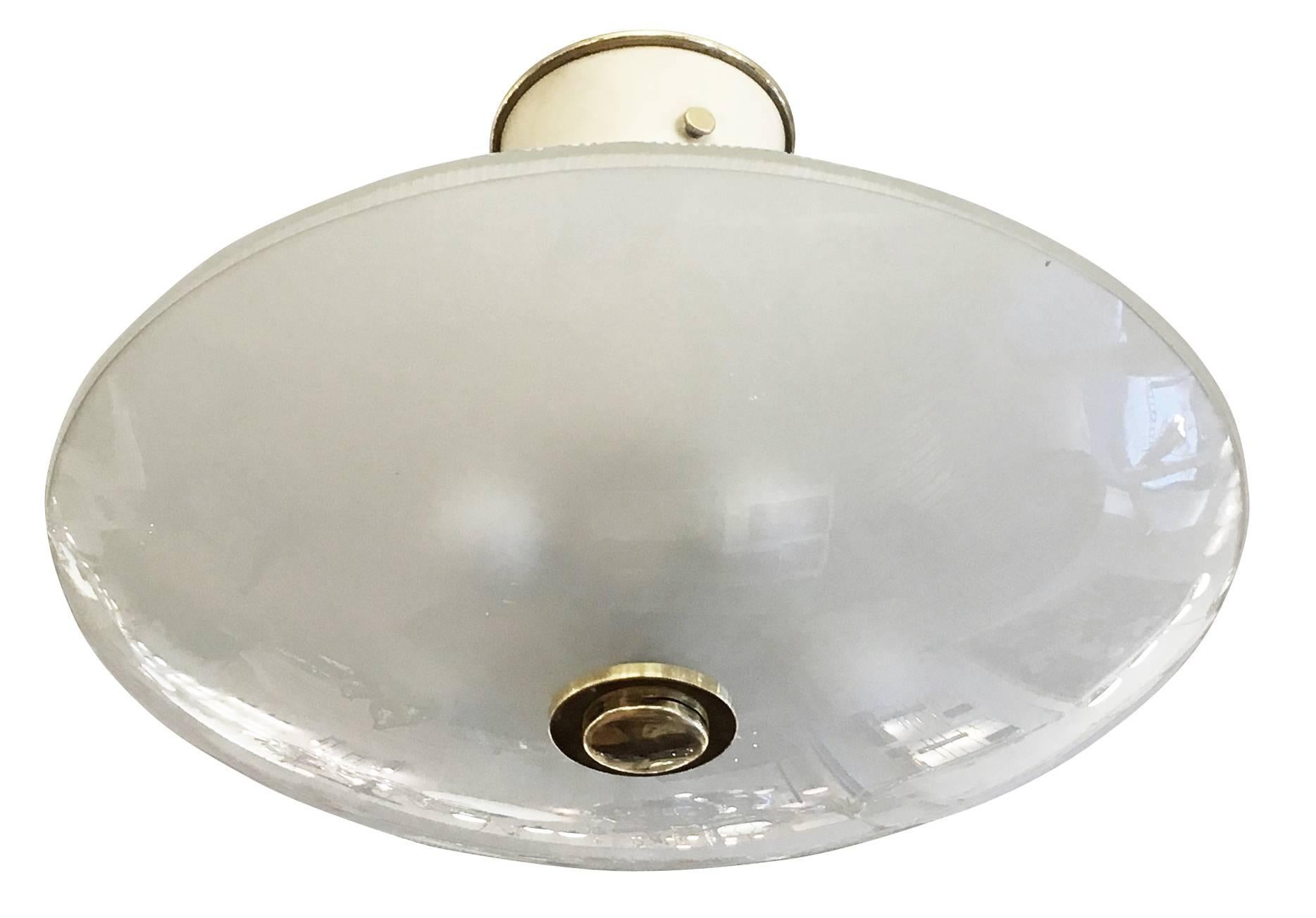 Charming glass fixture reminiscent of some Fontana Arte designs in the shape of an elliptical with on top a white lacquered conical ceiling mount. The body of the chandelier is composed by two glass dishes; the bottom one is frosted smooth while the