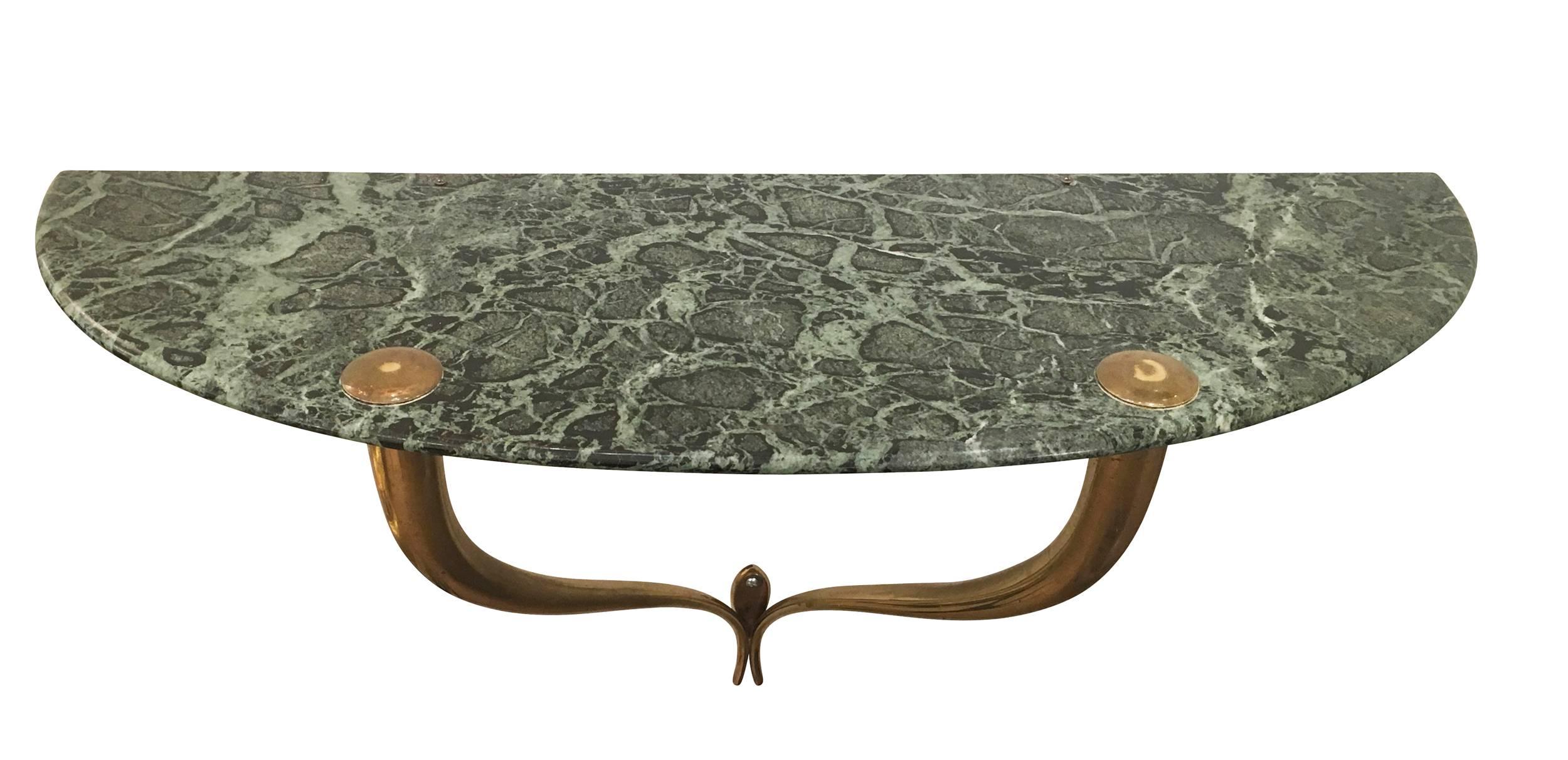 Beautiful wall-mounted console in the manner of Osvaldo Borsani from the 1950s. Its features a green marble top on a brass frame.