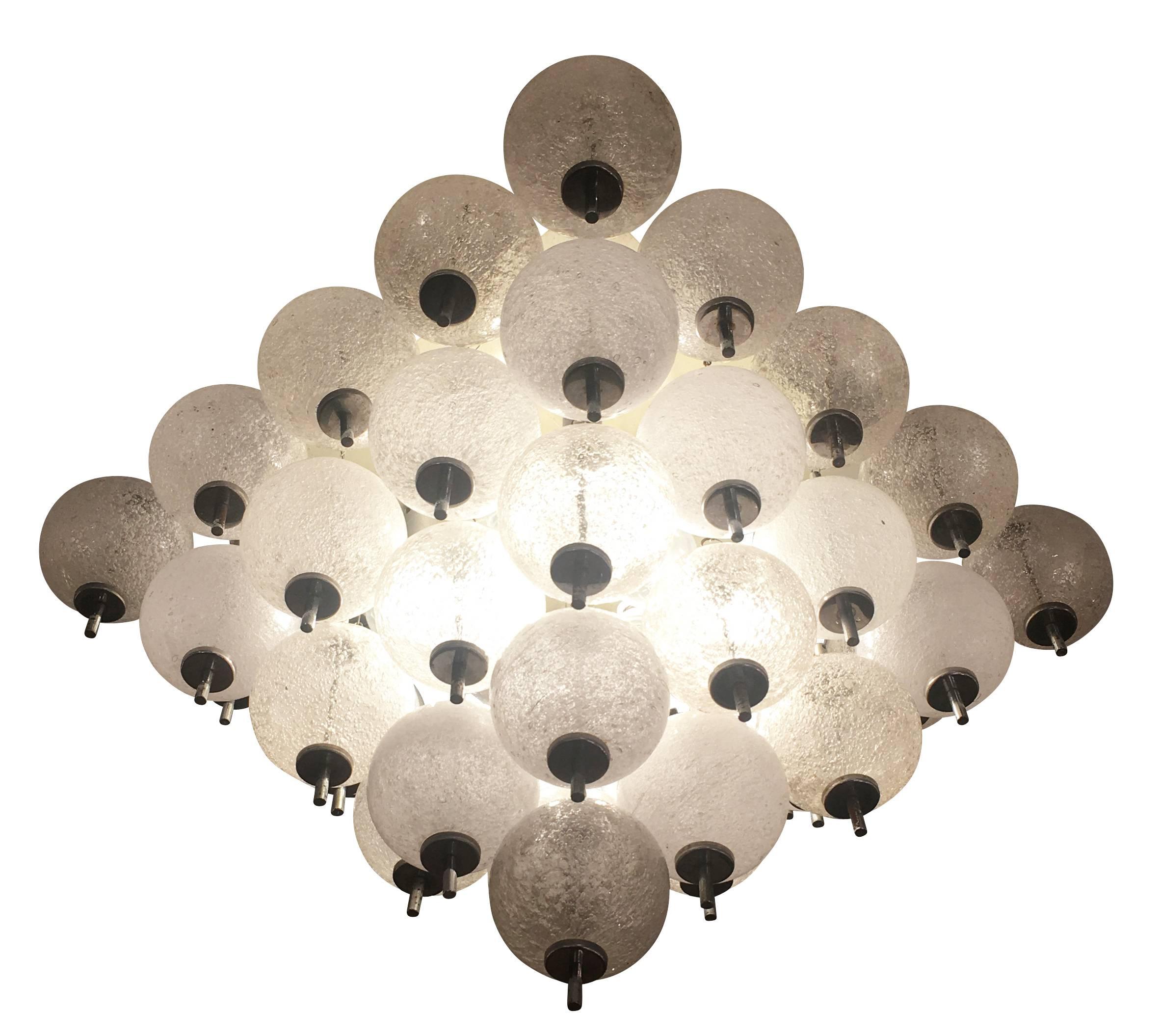 Flush mount fixture attributed to Murano glass manufacturer Seguso featuring dozens of glass spheres on a silver lacquered frame. The sphere are bubble infused creating a nice texture which hides the eight internal light sockets. Three rows of