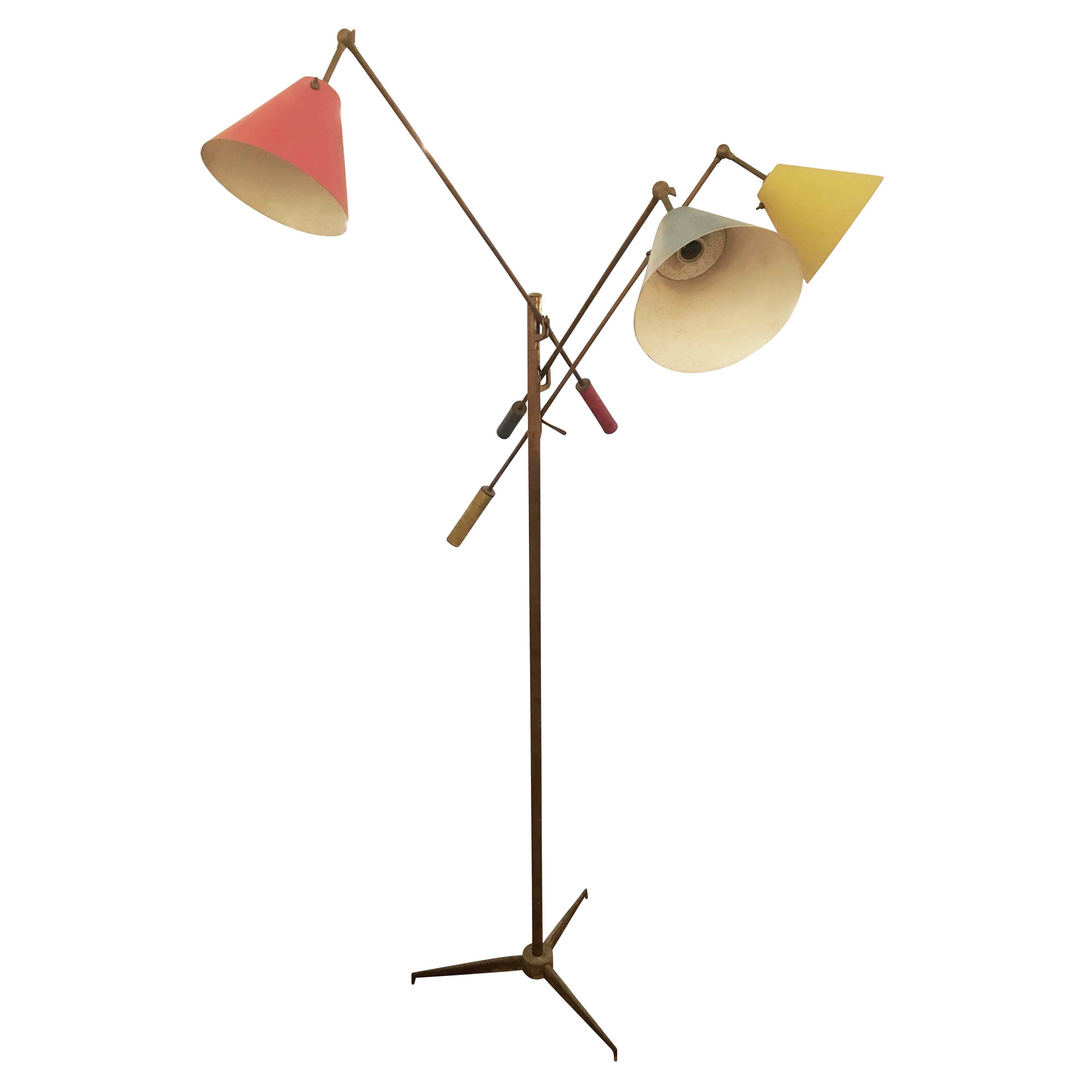 Timeless adjustable brass floor lamp designed by Angelo Lelli for Arredoluce in 1947. The piece is marked and has been left in its original oxidized condition for authenticity purposes but can be fully restored and polished at an additional cost.