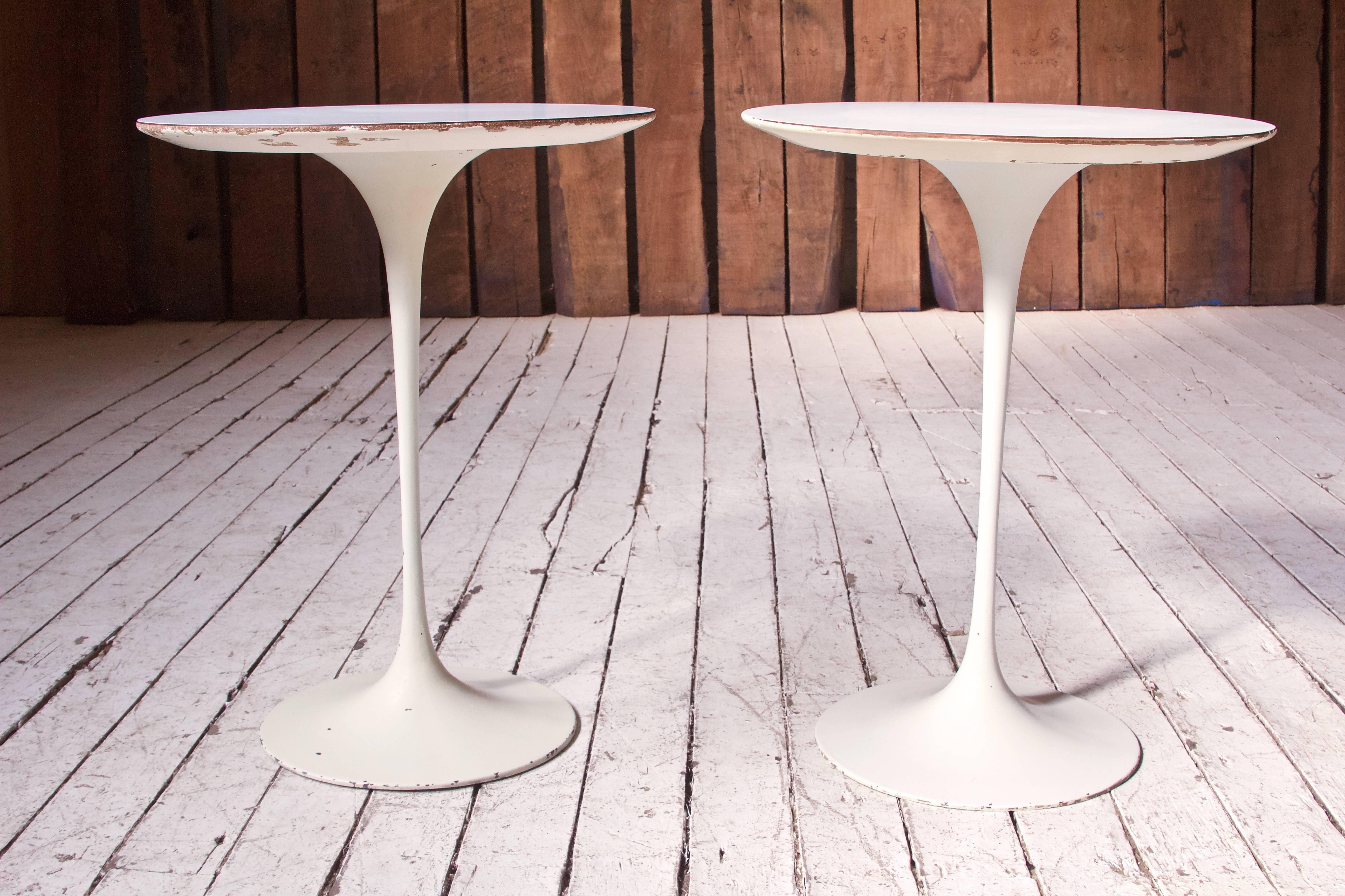 Lovely pair of early Knoll 'Tulip' side tables by the important and innovative architect Eero Saarinen in cast iron and white laminate, U.S.A, 1950s. These examples retain the original Knoll manufacturer's mark to underside and remain in good