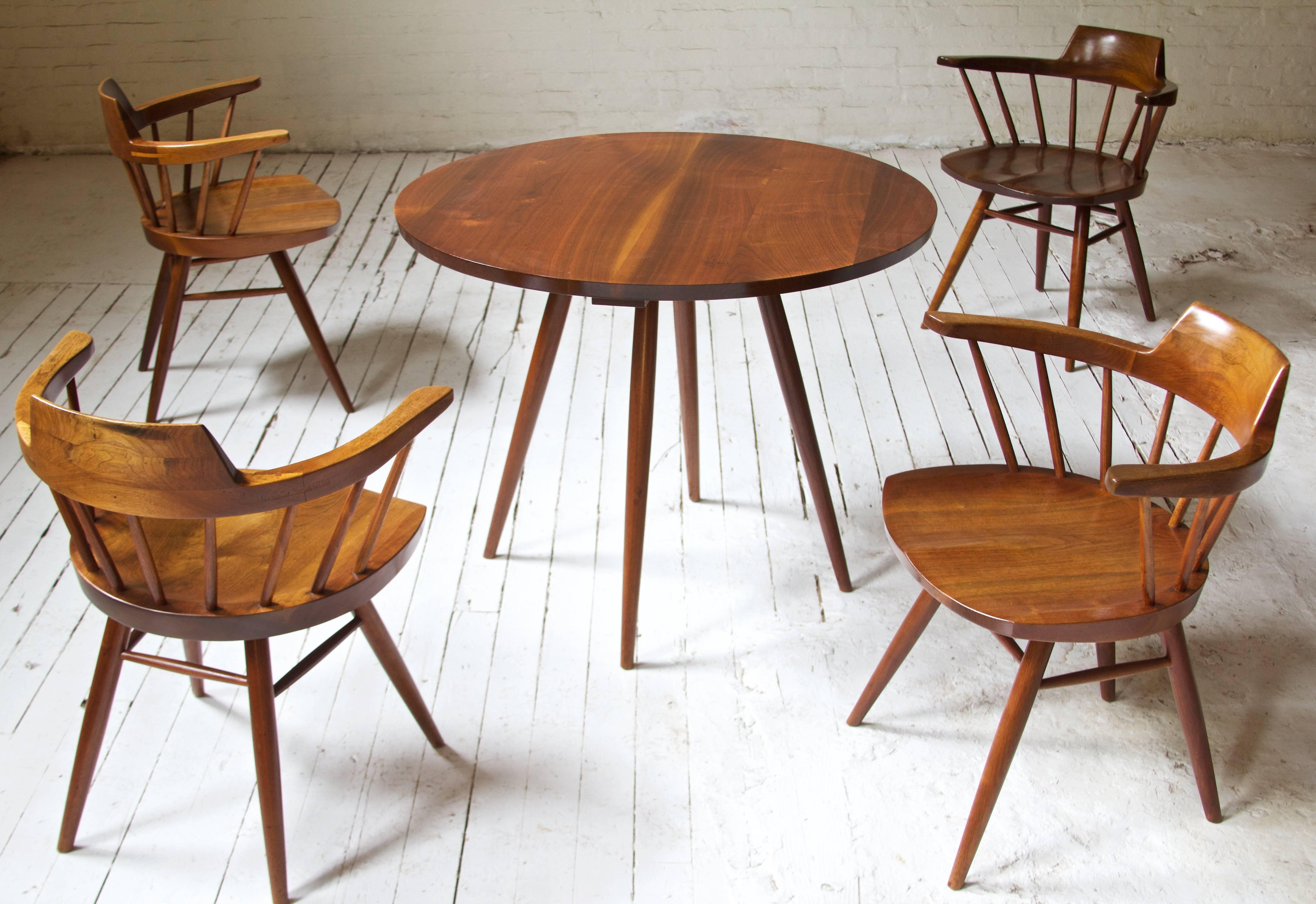 Rare single-owner dining set by George Nakashima featuring exceptionally-preserved splayed leg dining table and four carved-seat 