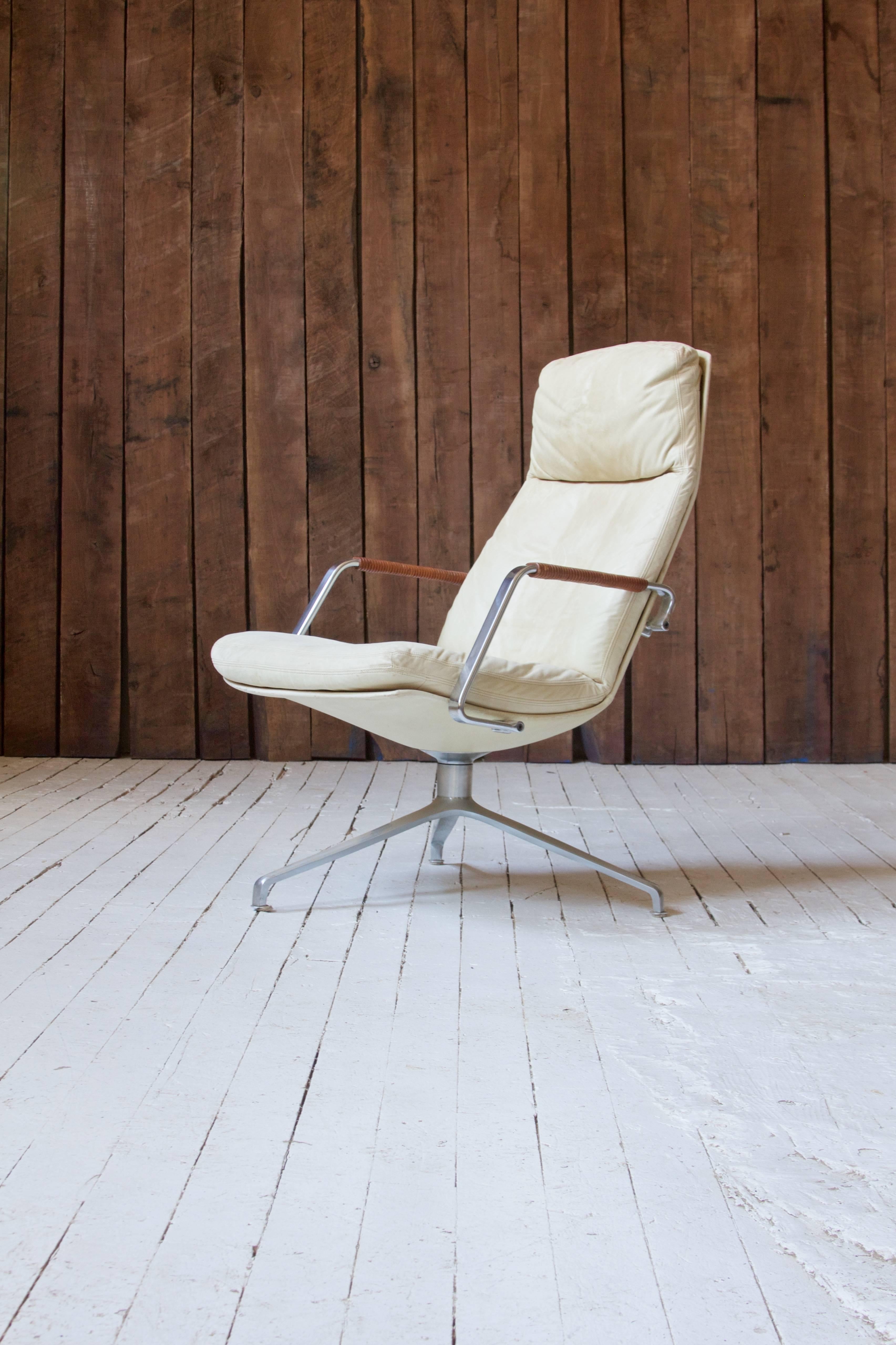 White leather and chrome-plated steel armchair with swiveling three-legged base by Jørgen Kastholm and Preben Fabricius. This design features the duo's signature leather cord wrapped arms and a soft, detachable seat/back cushion.