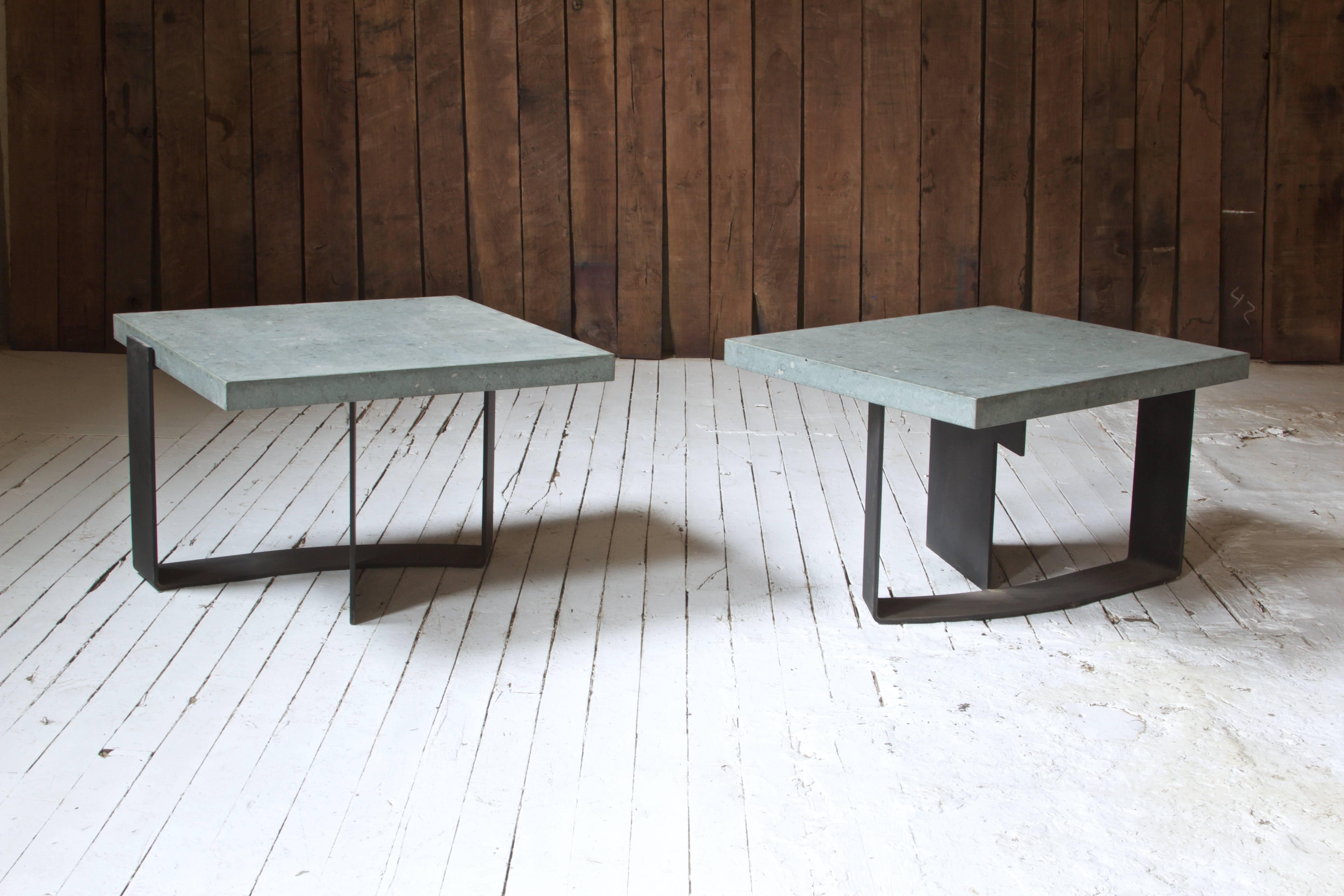 Great pair of fossiliferous limestone and enameled steel side tables; handmade in Italy, circa 1975. A simple yet dynamic design, the base's unique shape allows the table's appearance to change with new perspectives--negative and positive space