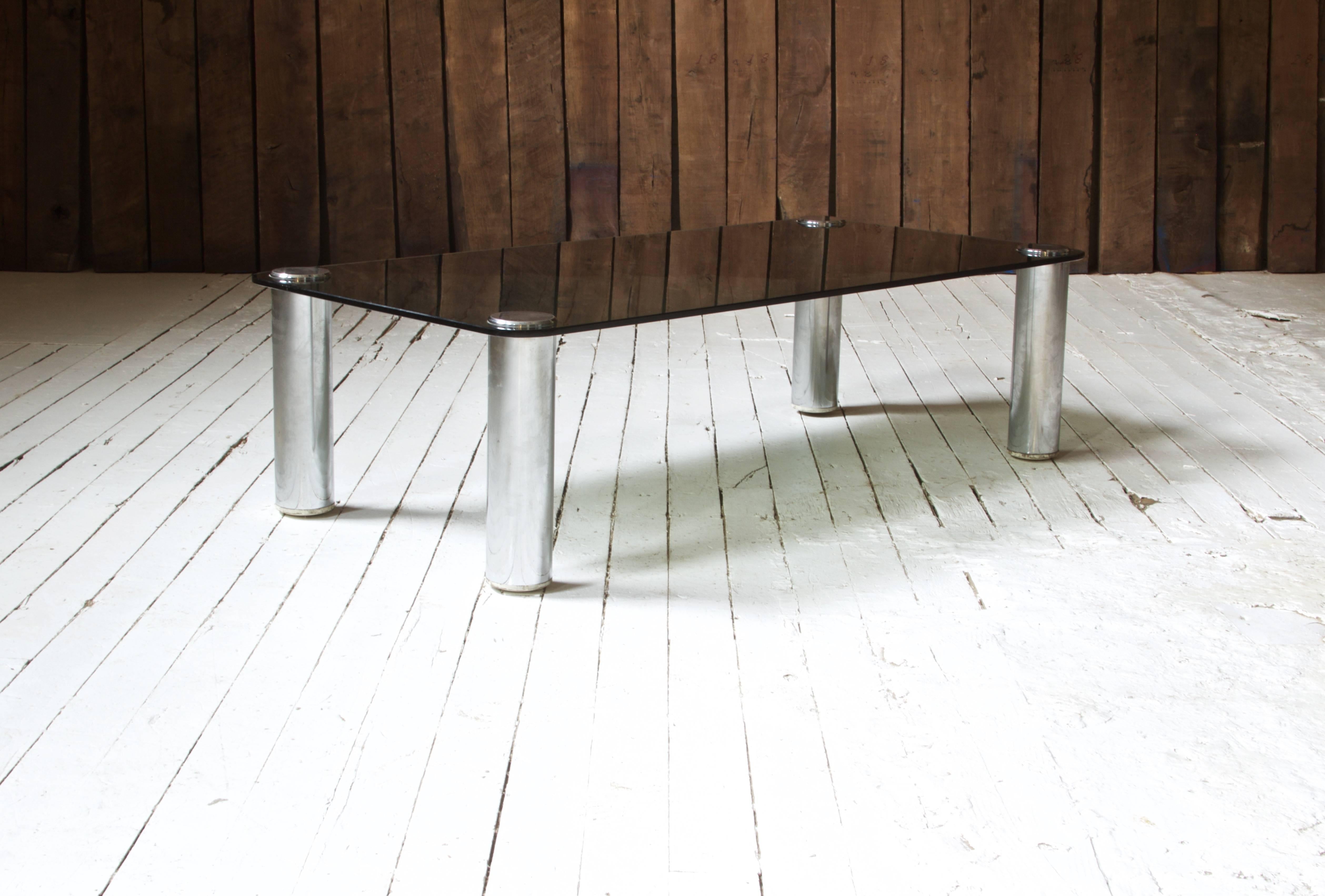 'Marcuso' coffee table with original smoked glass top supported by four chrome-plated steel screws on legs. This piece was designed by noted Italian architect Marco Zanuso, circa 1960; manufactured by Zanotta, circa 1965 table has been documented in