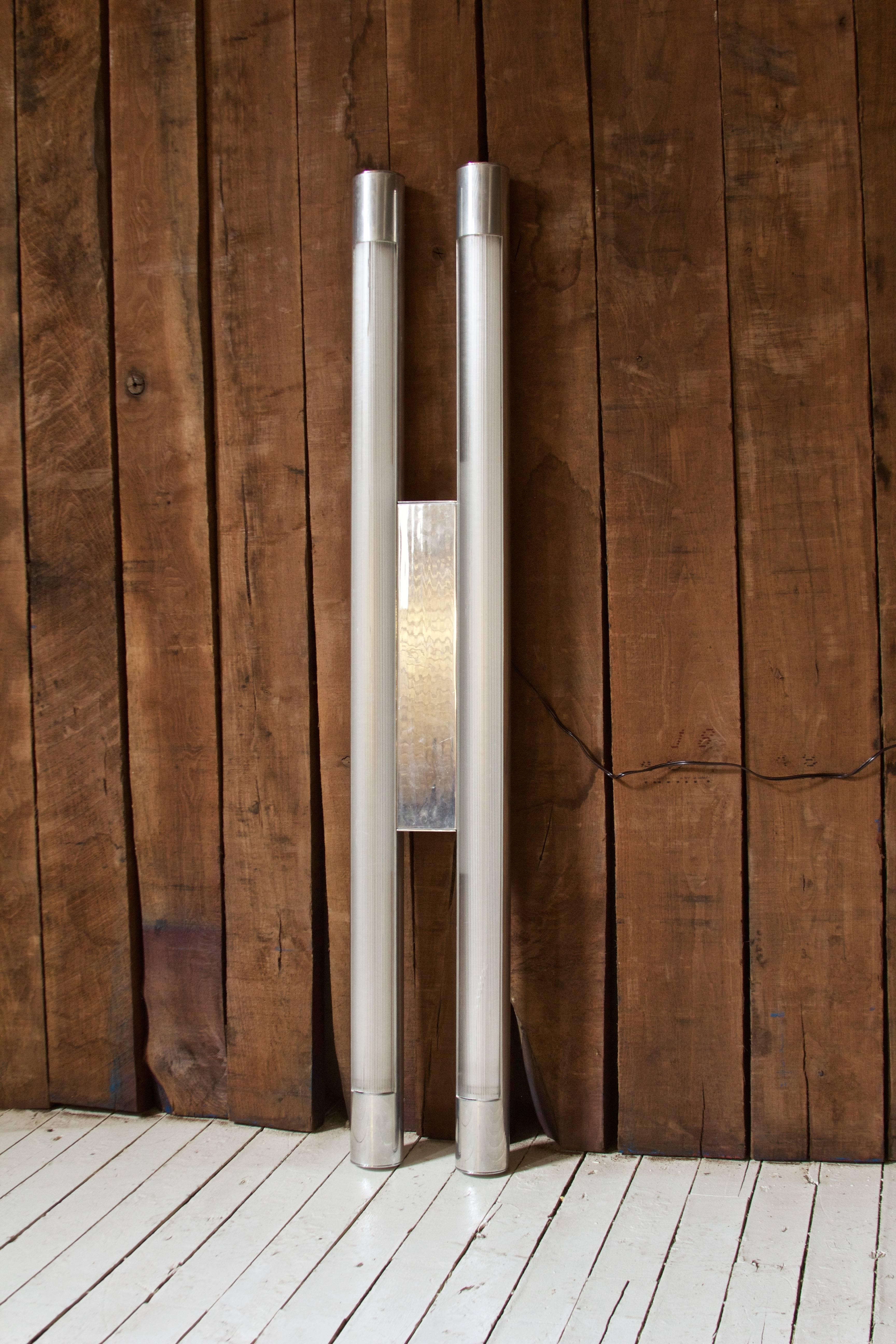 Unique and impressive aluminum light by Paul Mayen for Habitat International, circa 1968. This well proportioned design consists of two polished aluminum cylindrical sections joined midway by polished aluminum rectangular panel; each section houses