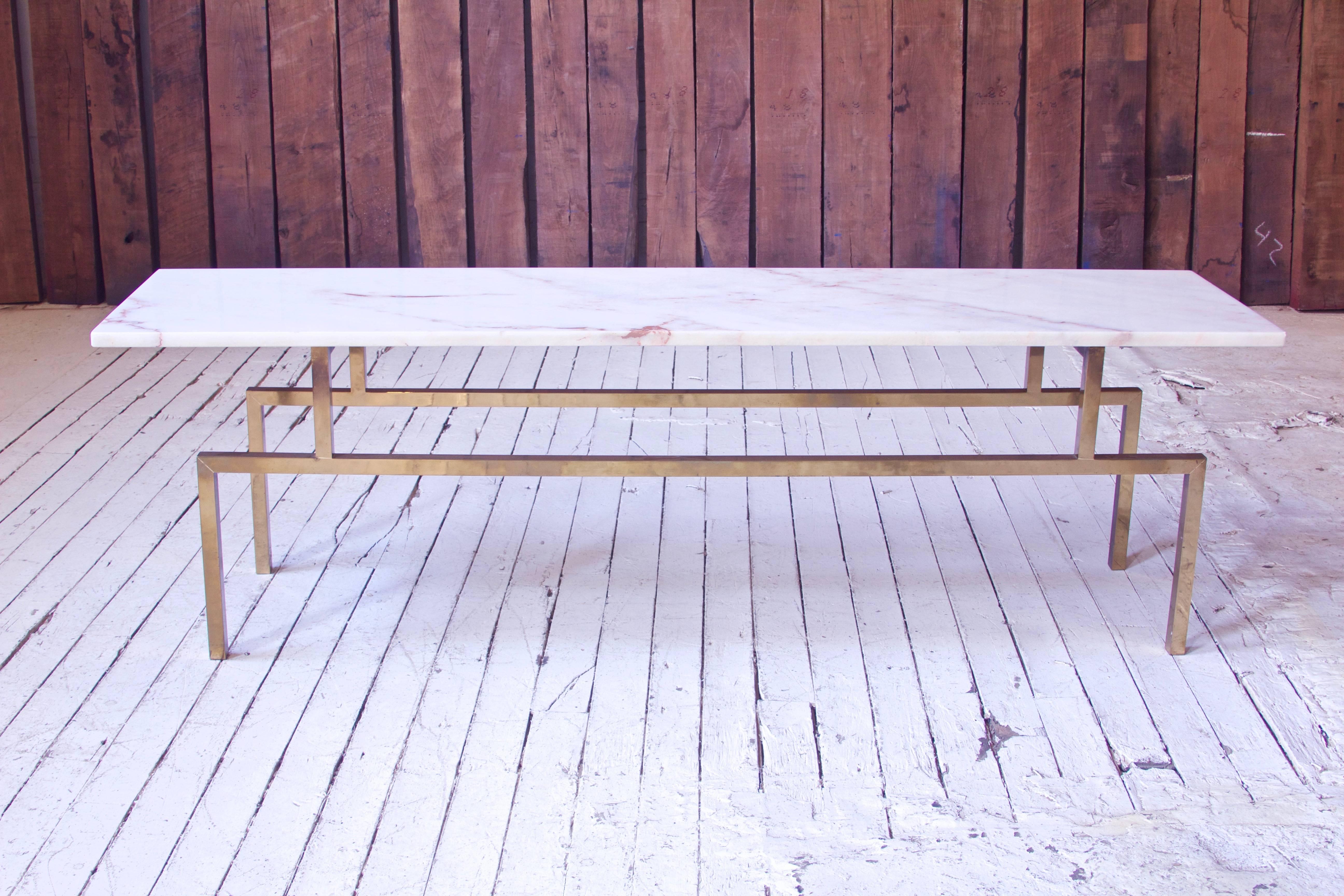 Quality low table in figured white marble with geometric brass base. Excellent metalwork in the base, richly figured top...a simple yet attractive piece. Lovely warmth to the brass base.