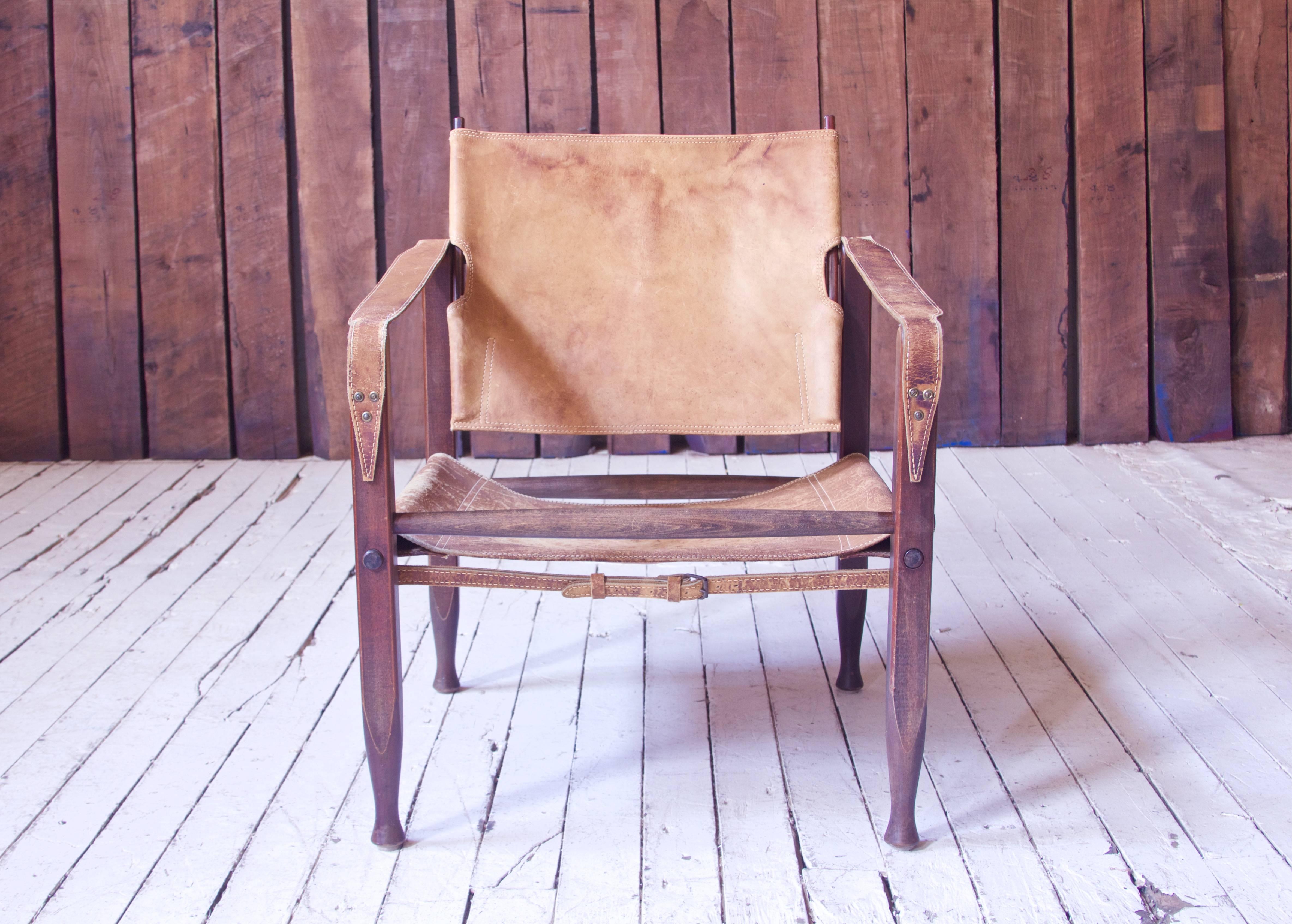 Lovely early example of Kaare Klint's ever-popular "Safari Chair" in original cognac leather and stained Beech. Inspired by the collapsible Campaign chairs of English officers on the African Savannah, Klint designed his own modernized