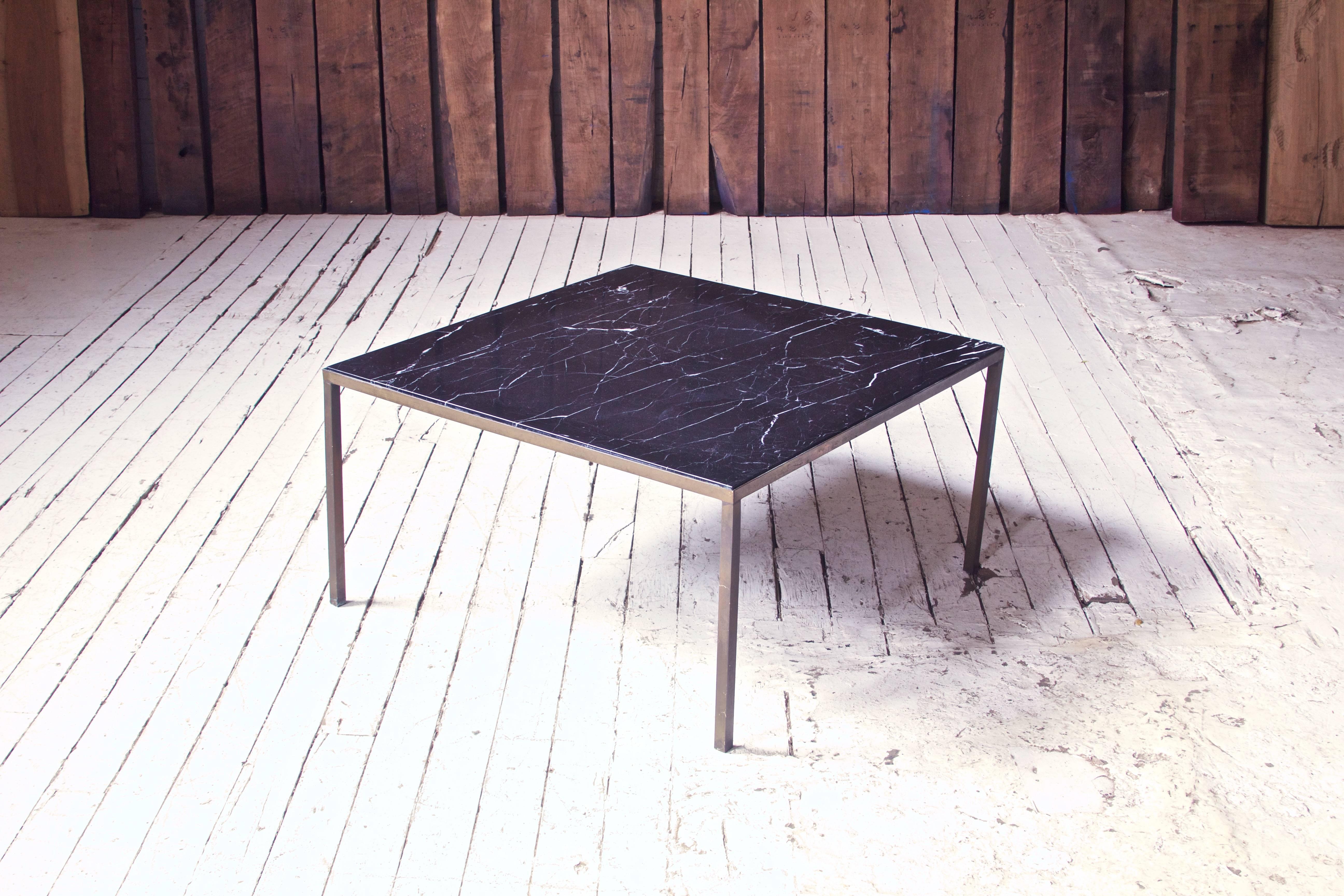A perfectly unadorned vintage Italian coffee table with stunning polished black marble top and gorgeously patinated welded bronze base.