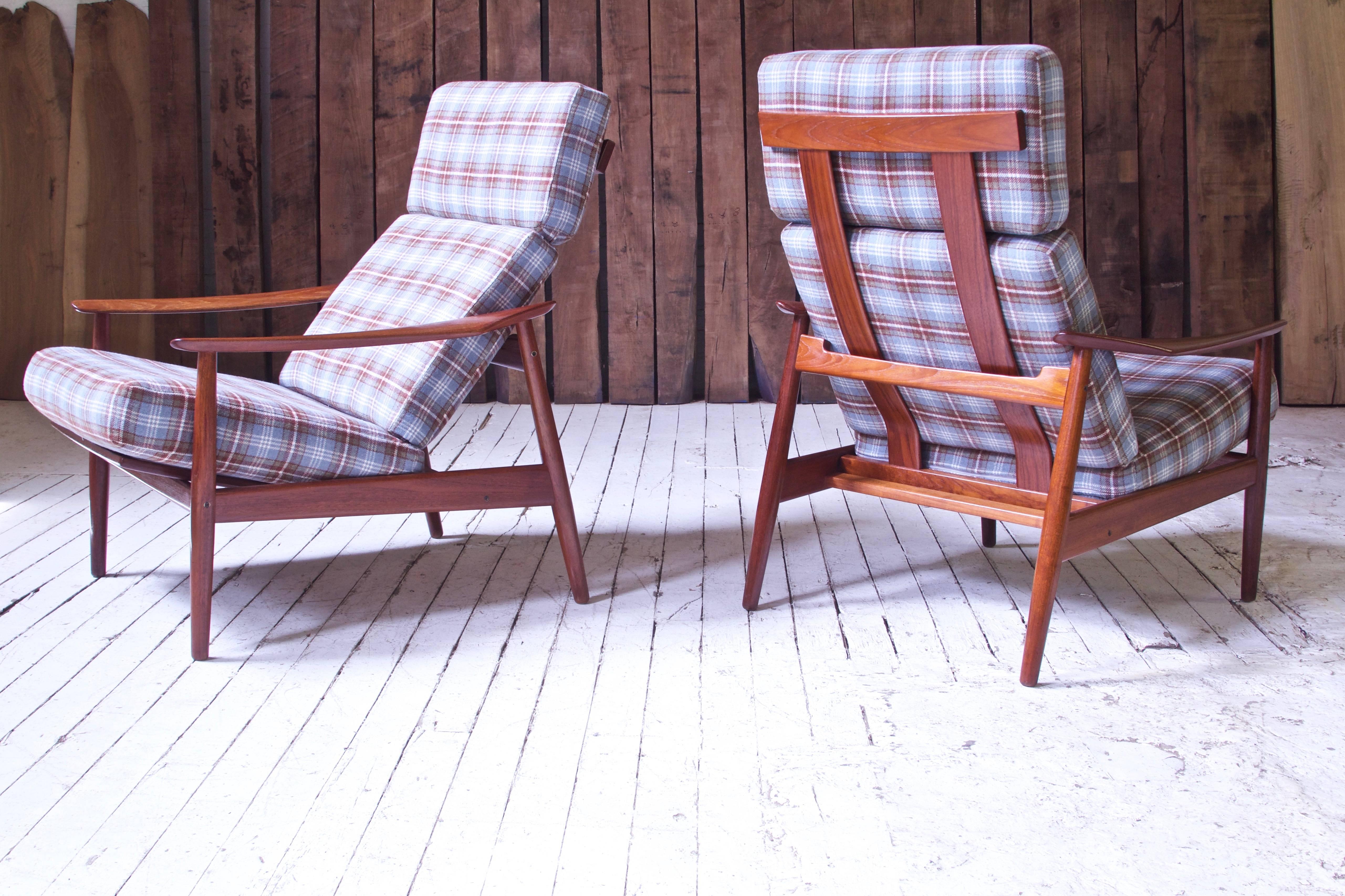 A well preserved pair of stunning and unique reclining lounge chairs in teak and plaid wool designed by the prolific Arne Vodder for France and Son, imported by John Stuart Inc, circa 1960. As with the best of Danish seating design, no ergonomic