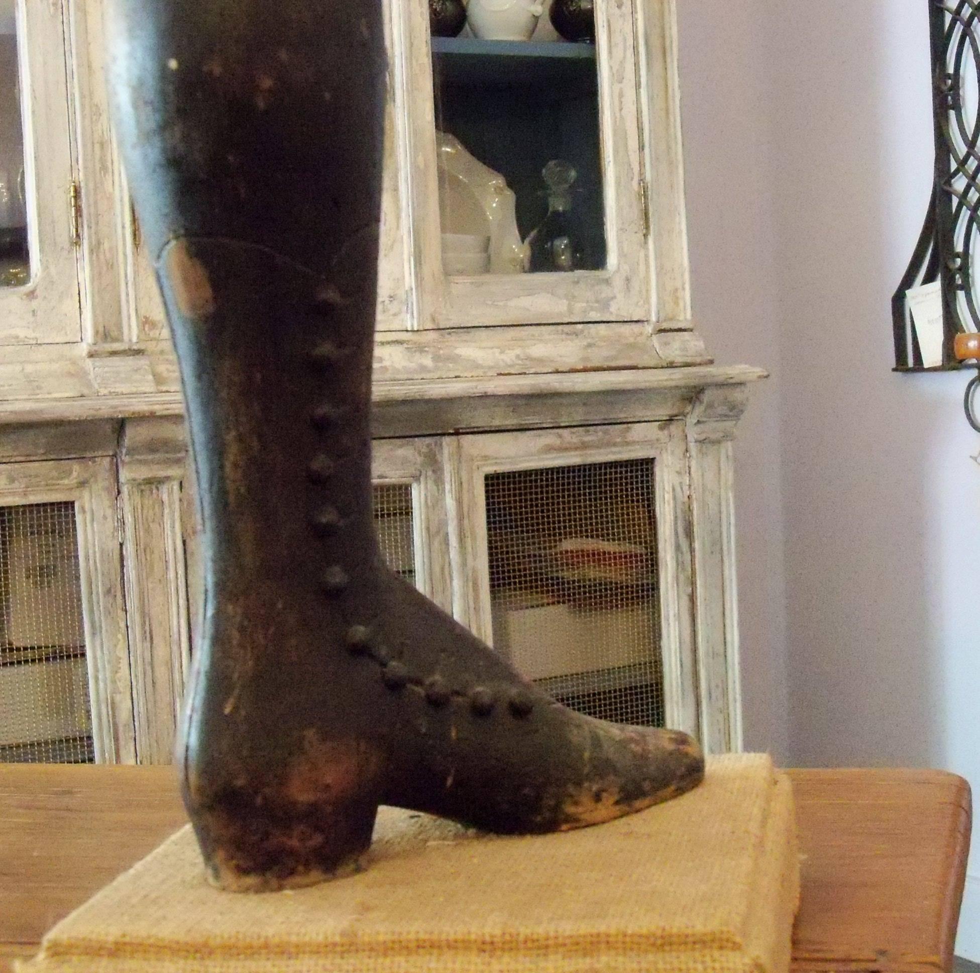 French wooden painted mannequin calf and foot carved to depict a woman's high button boot, with scalloped top, extending half way up the leg, circa 1880 The piece has been repurposed into a lamp with a burlap covered wood base and burlap shade with