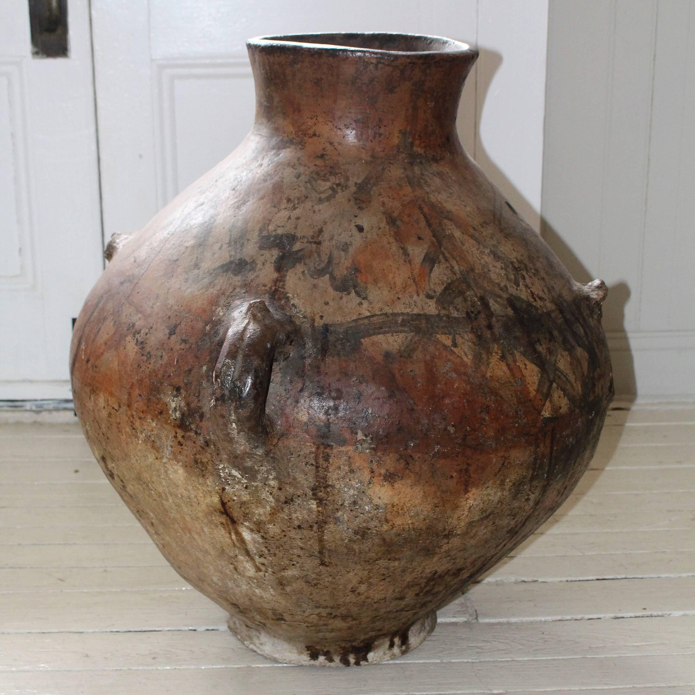 Monumental terra cotta Moroccan oil jar, late 19th century, with timeworn tribal markings.
