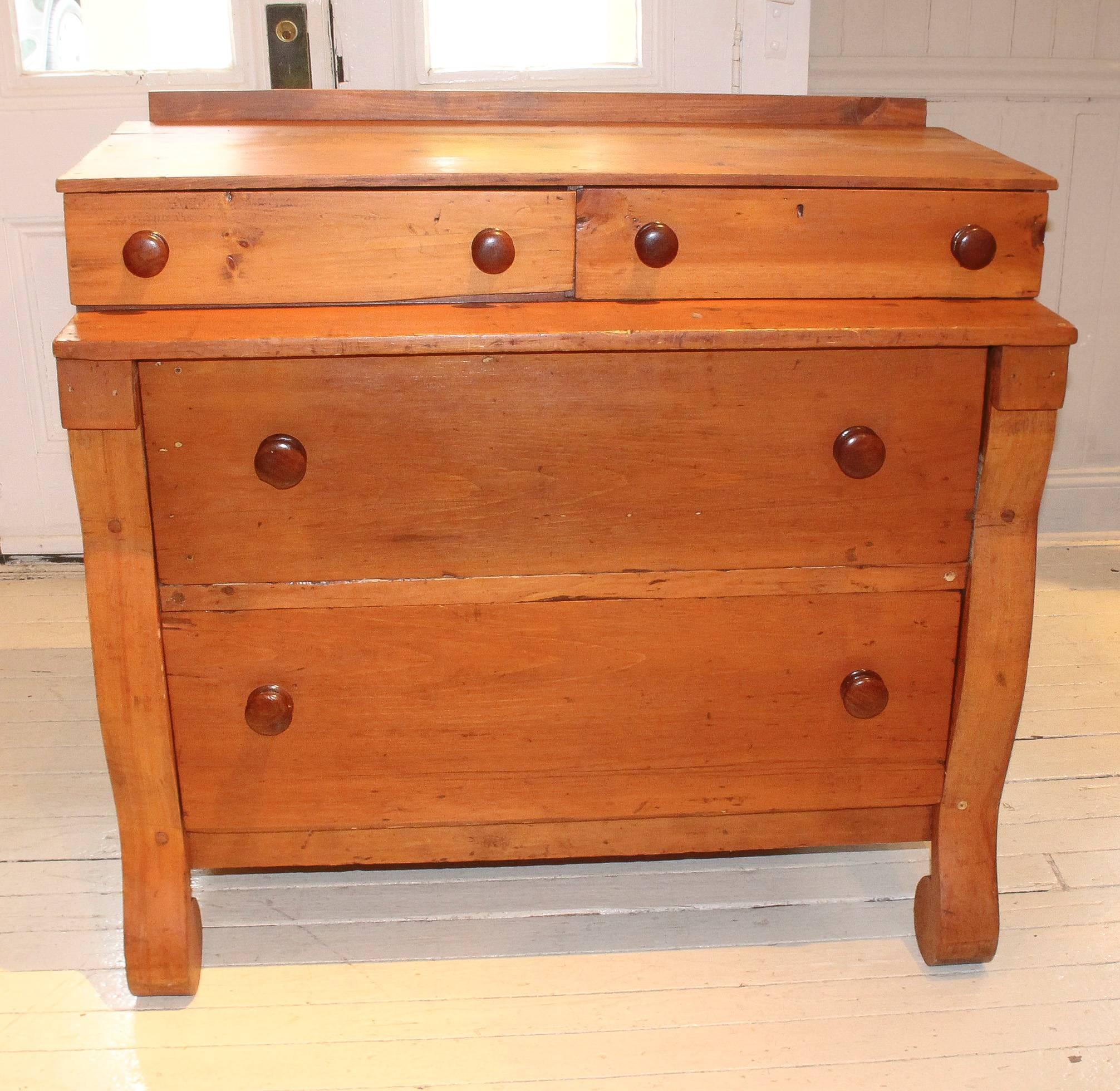 Benchmade vintage pine chest, 1960s, American, with two recessed drawers atop double drawers, all with wood knobs. Bottom drawers are edged with curvaceous side moulding culminating in scroll feet.
