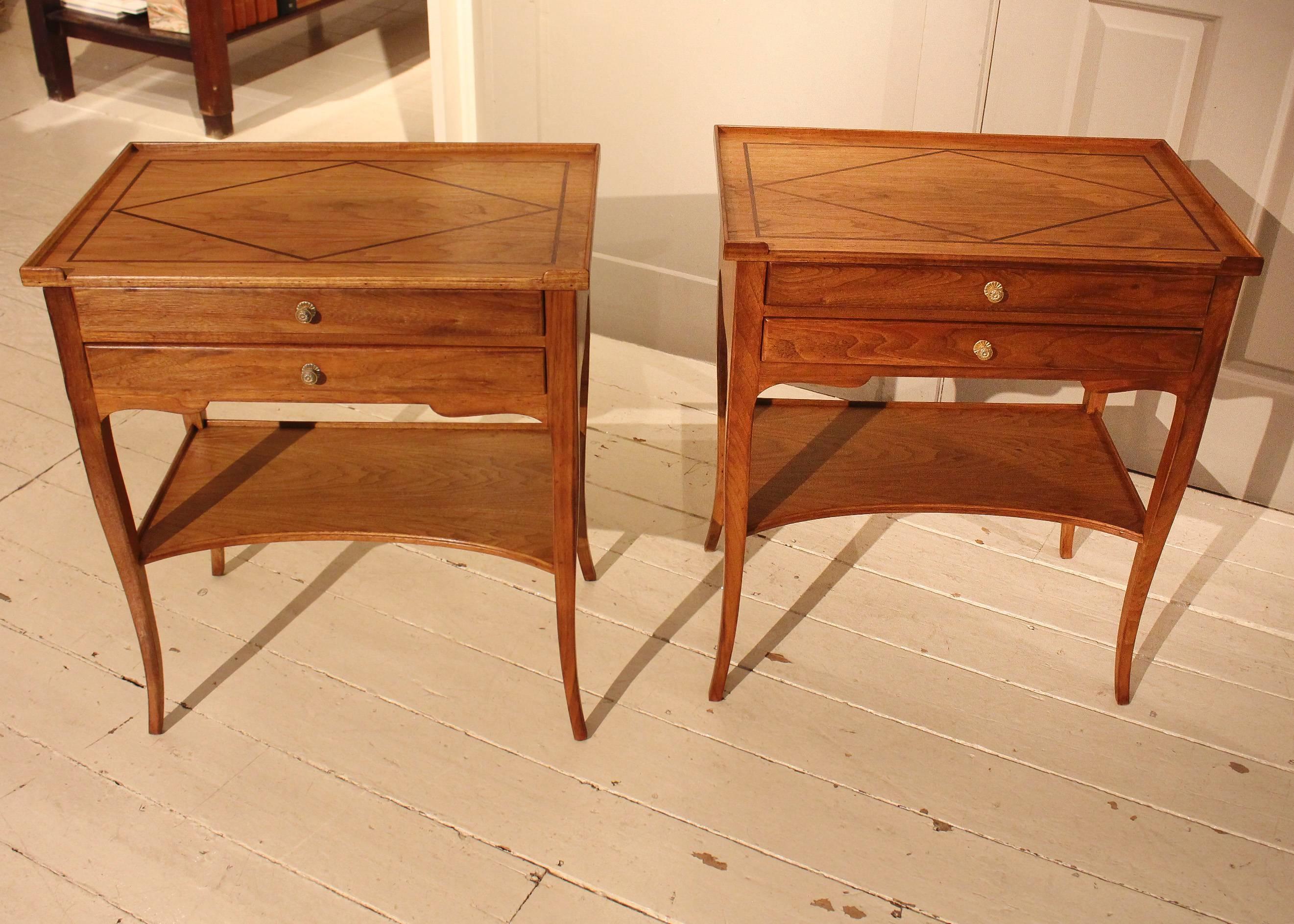 Pair of light walnut side tables, early 20th century France, with inlay galley top above two drawers and lower conclave-shaped shelf, raised on cabriole legs.