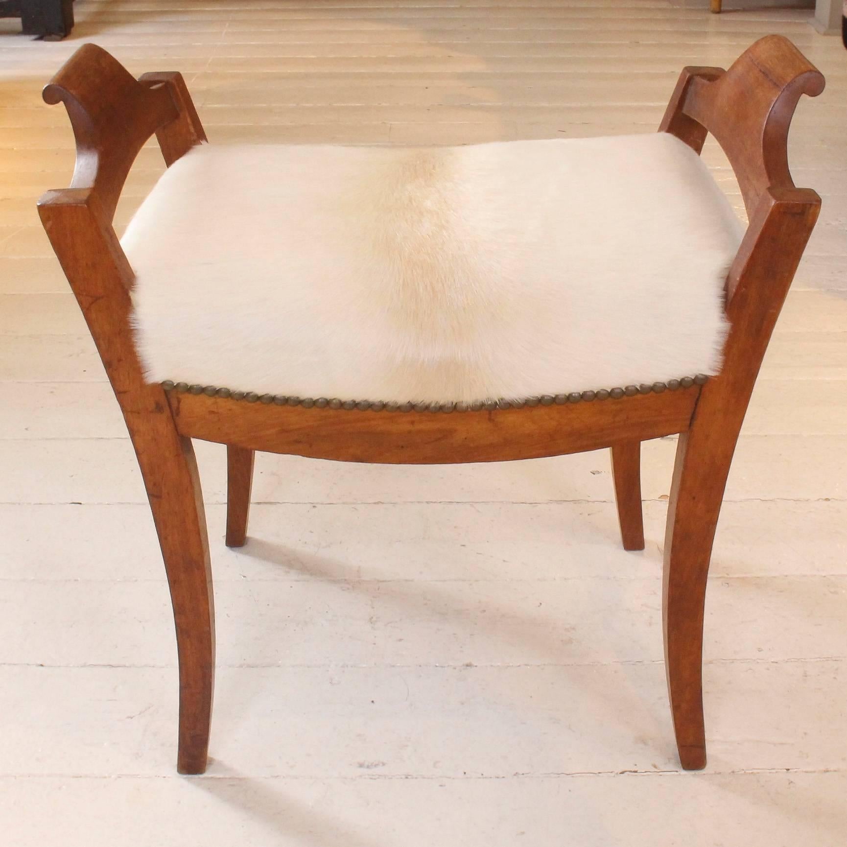 Petite bench, 19th century Sweden, in the Karl Johan style with seat in ivory calfskin.
