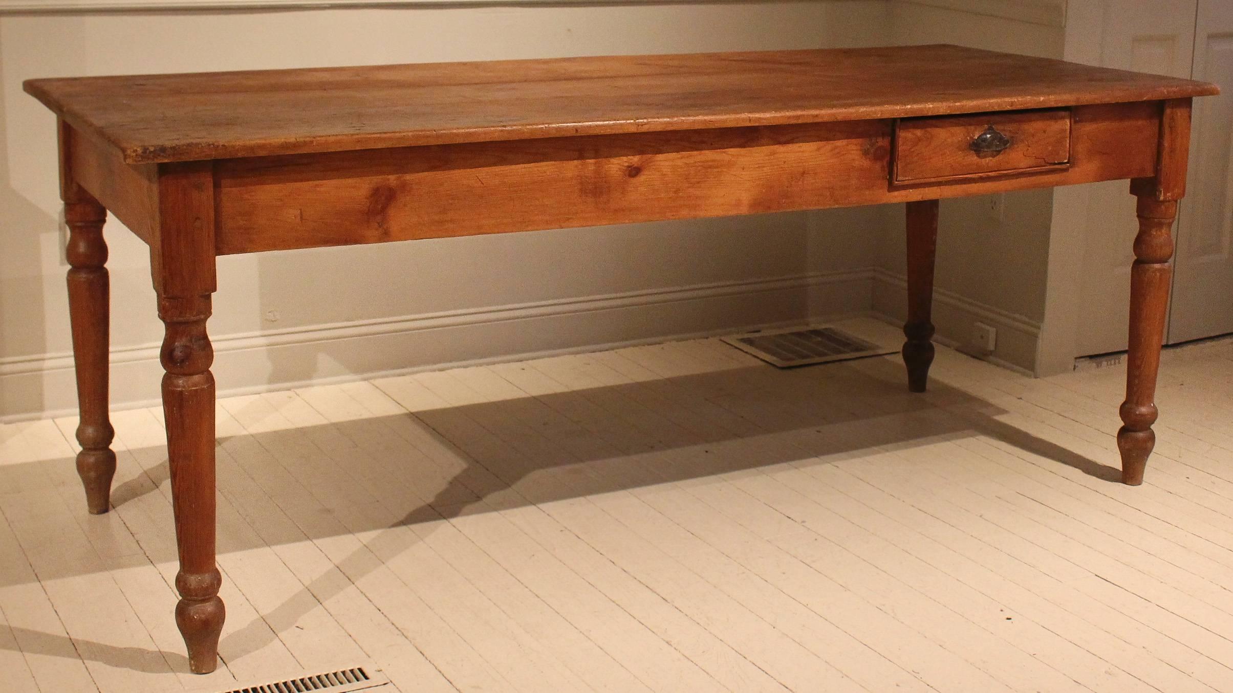 Early 20th century Brazilian work table with triple plank top and single drawer tucked into apron. Table, which is raised on turned legs, has a wonderful timeworn patina.