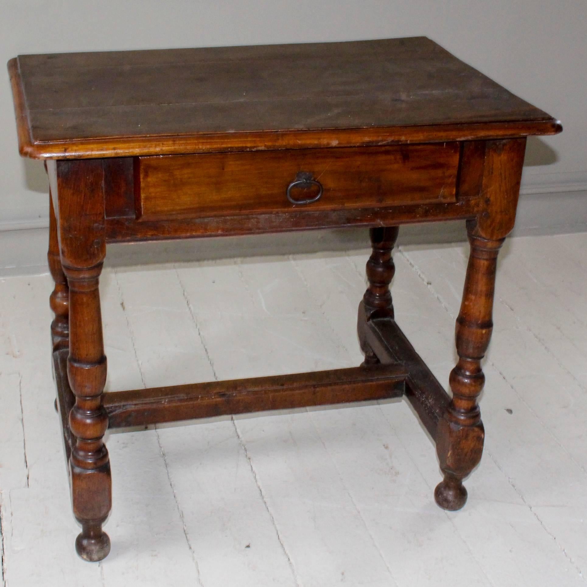 Single-drawer side table, 18th century France, with pegged construction. Table sits on turned legs and feet with cross stretcher.