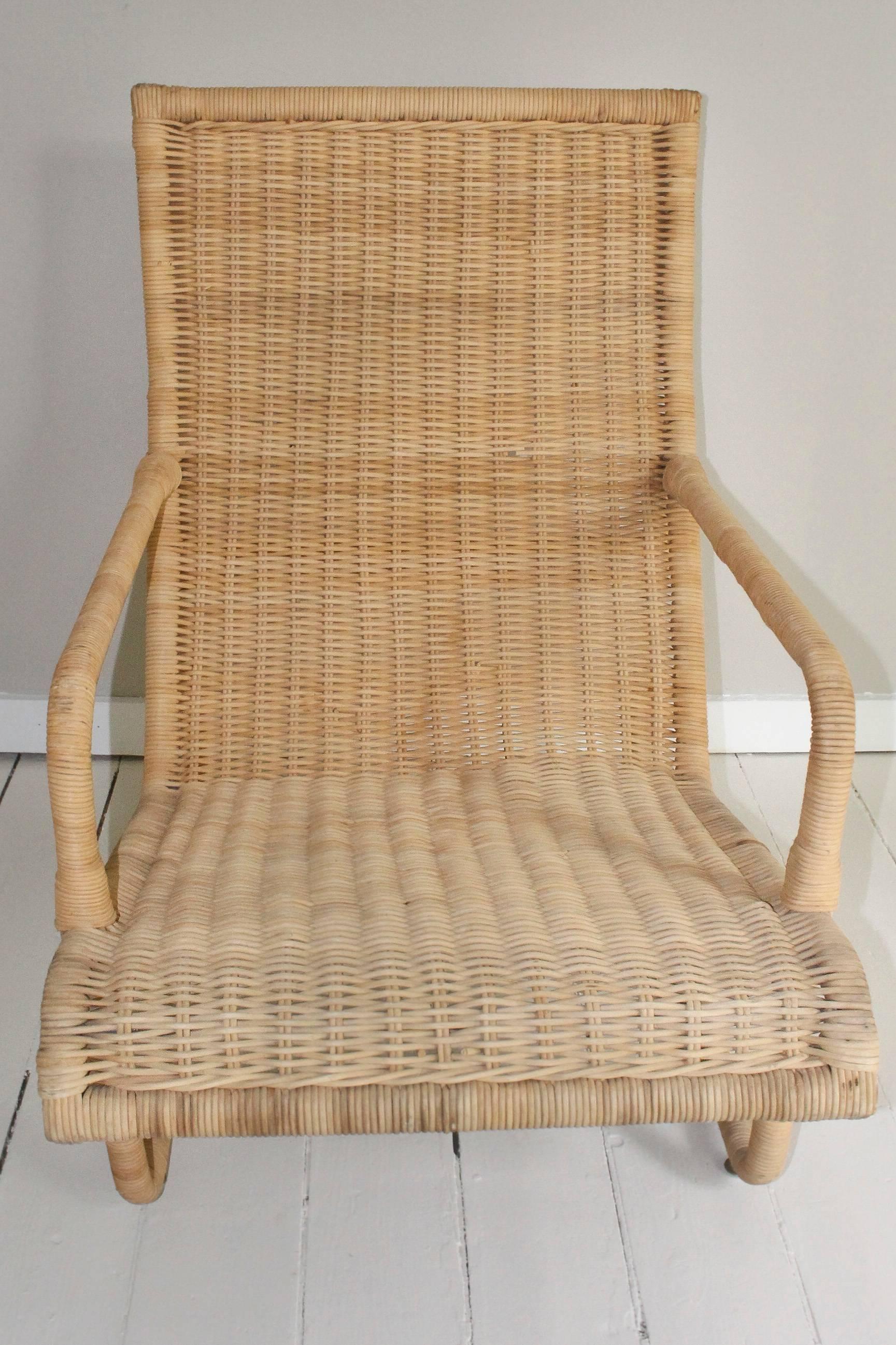 Out-of-production handcrafted Bielecky woven Rattan armchair with sculptural lines.