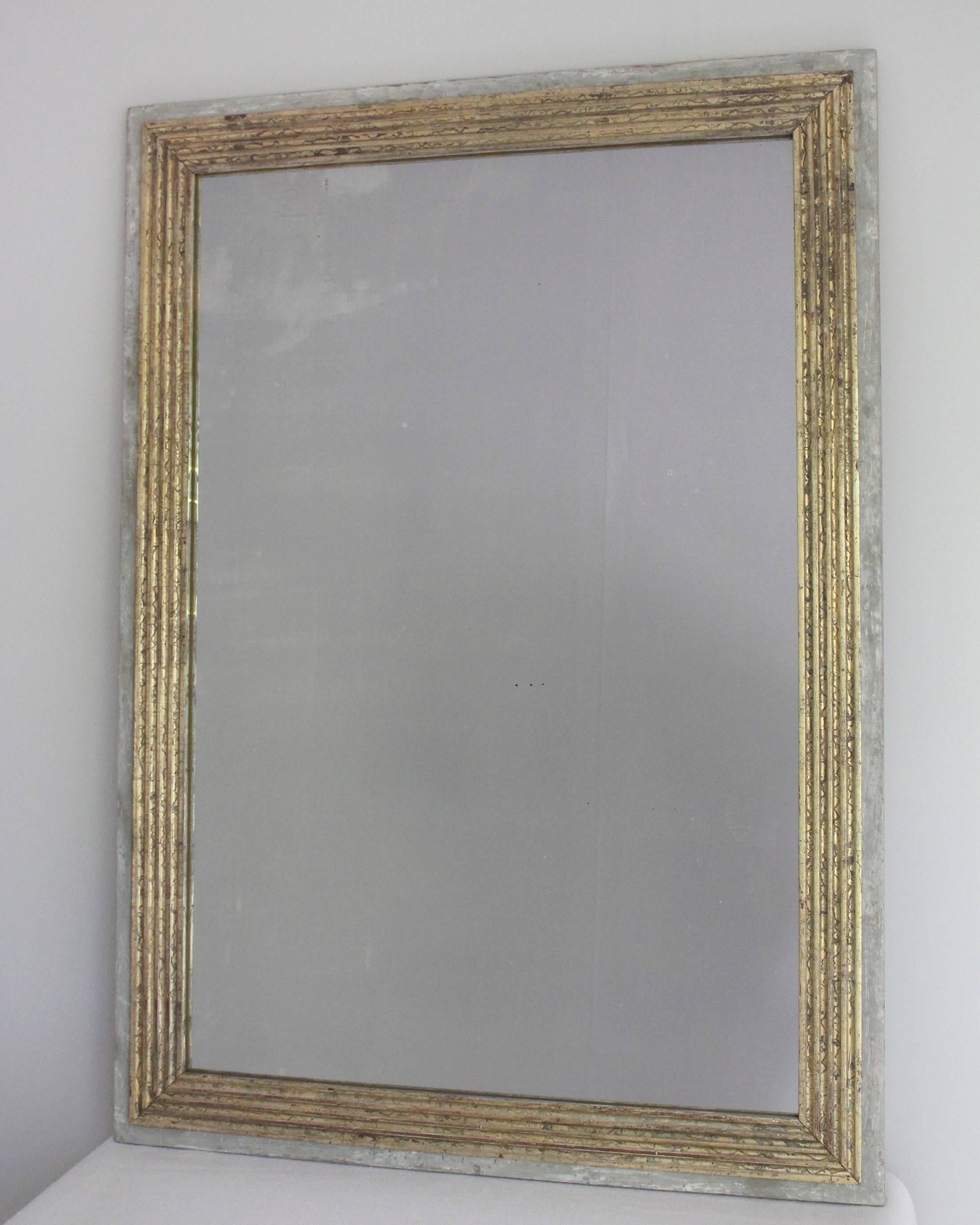 19th century Directoire style rectangular mirror with fluted giltwood surround mounted on painted base, with later gilt and paint.